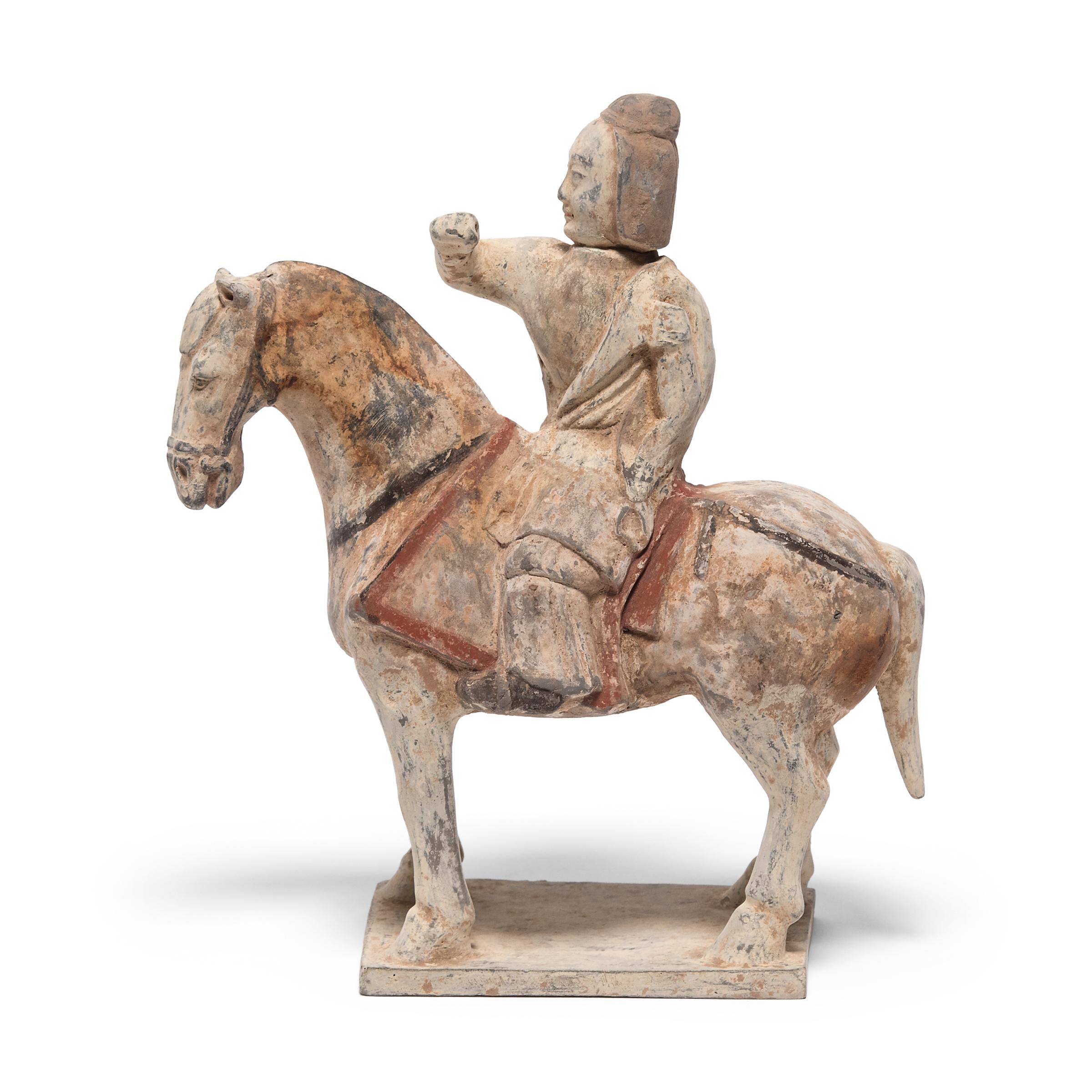 This dignified equestrian is a soldier from the Northern Qi dynasty, and was sculpted in Shandong province over 1,500 years ago as a míngqì burial figure for a wealthy nobleman. Depicting the pleasures of daily life, míngqì figurines were offerings