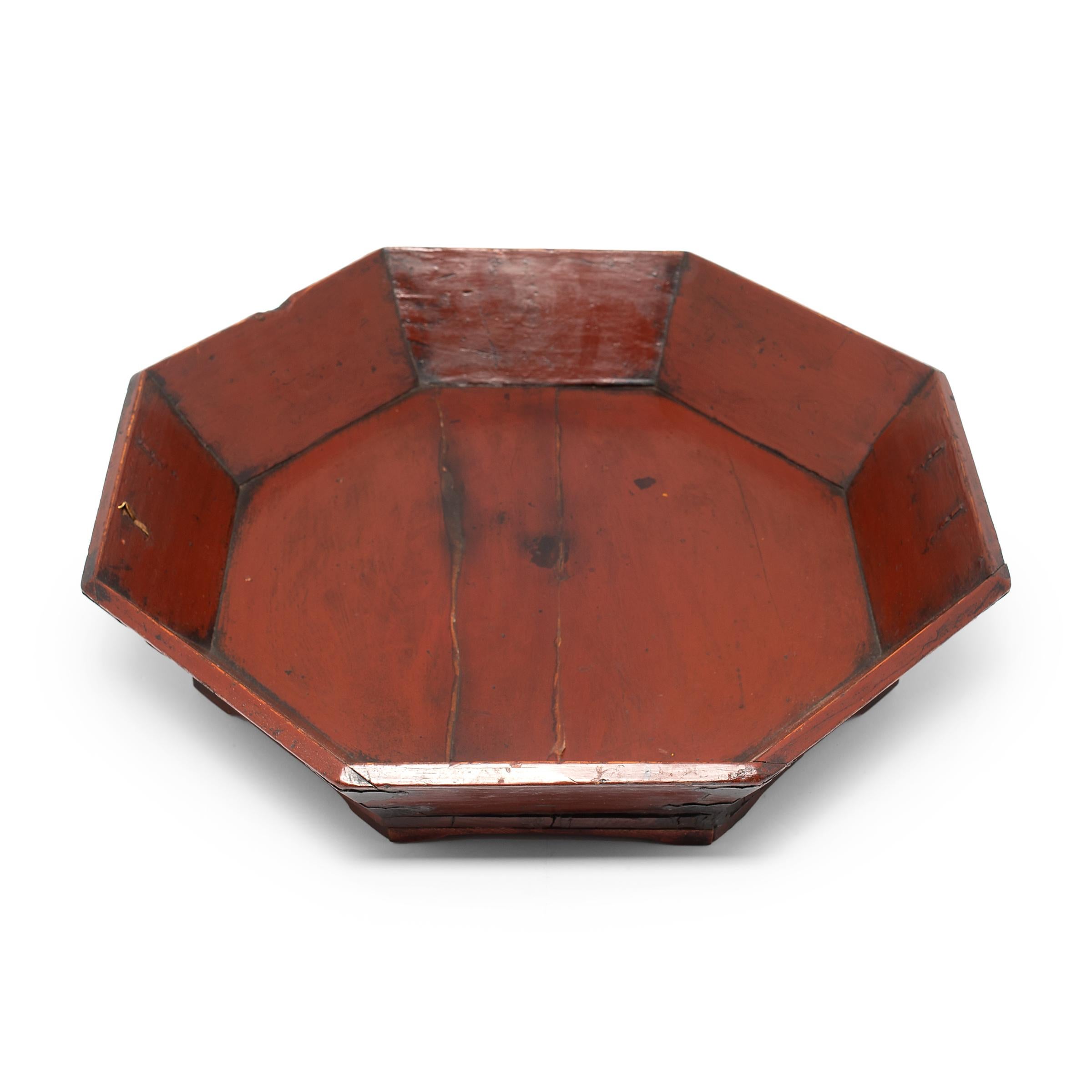 This late 19th-century tray is crafted of northern elm (yumu) with eight sides, an auspicious number associated with wealth and abundance. The tray has a short footed base and flared sides reinforced at the corners with cloud-form iron plates.