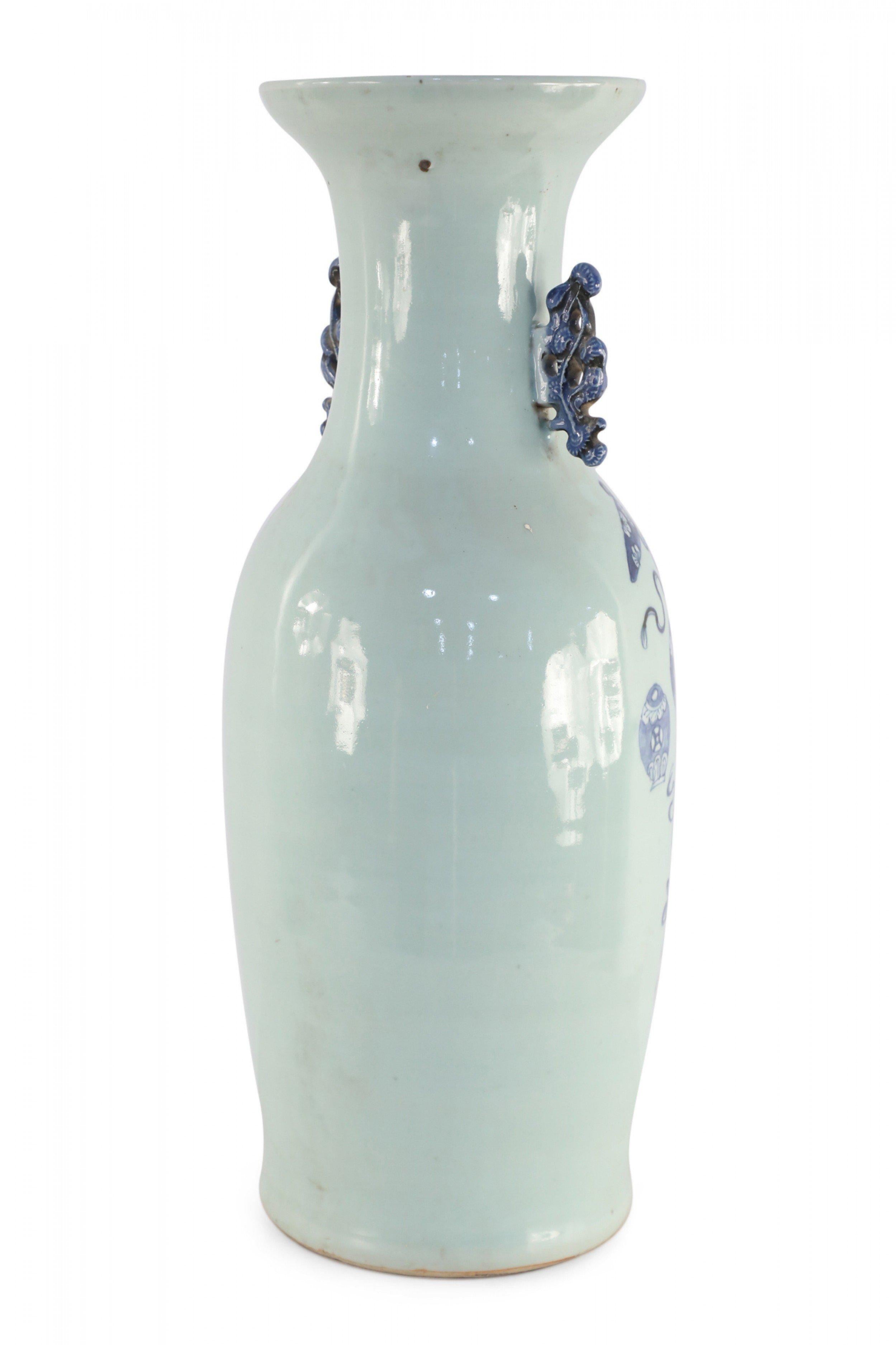 Antique Chinese (Late 19th Century) large, off-white porcelain urn painted with a blue pattern featuring Buddhist symbols and other shapes with accented blue scrolled handles.
 