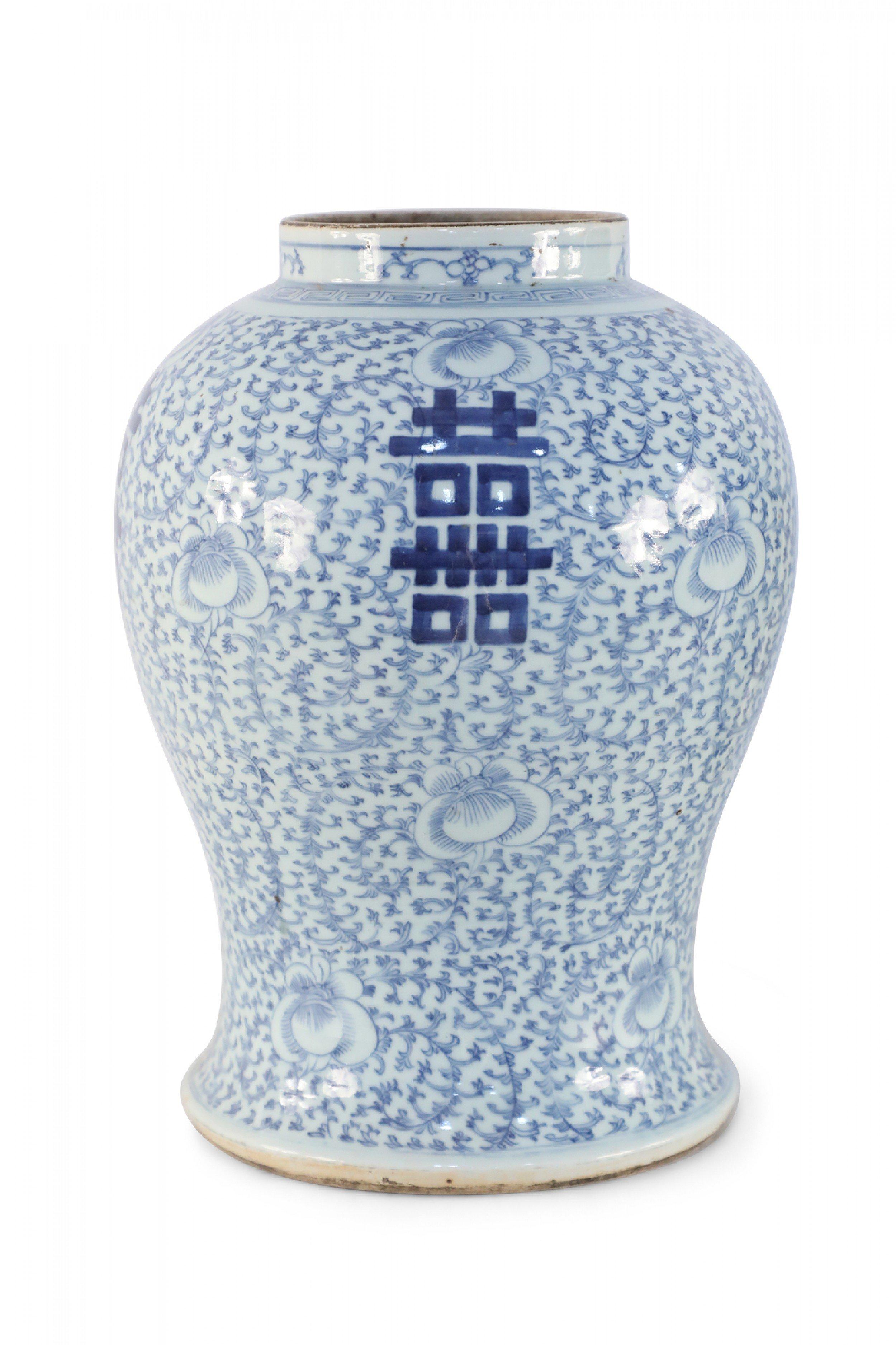 Antique Chinese (Early 20th Century) off-white porcelain vase with an urn form decorated in a light blue, delicate vine and floral motifs and bold characters on 4 sides.
 