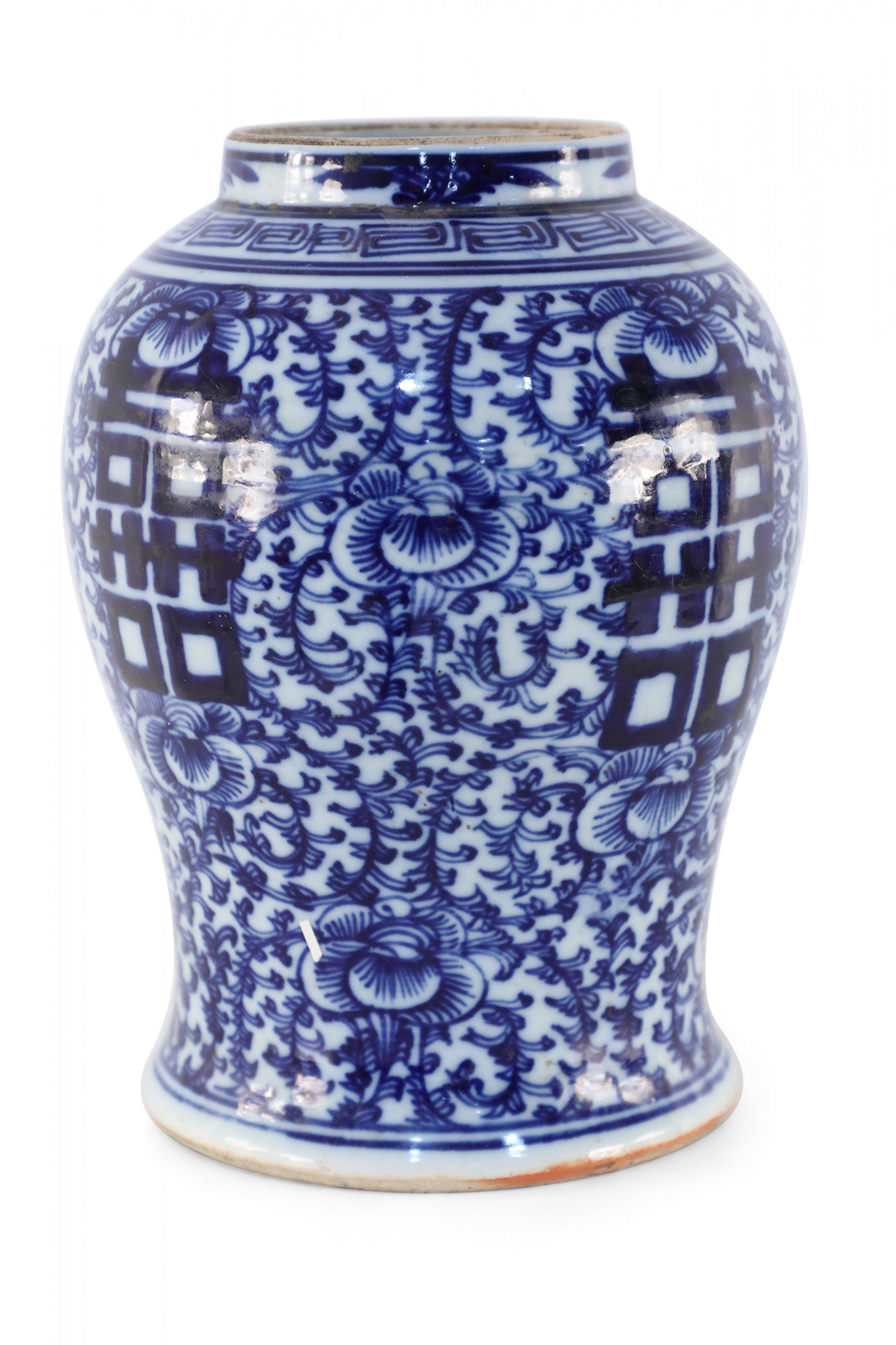 Antique Chinese (Early 20th Century) off-white porcelain vase with an urn form decorated in a navy blue vine and floral motifs and bold characters on 4 sides.
 