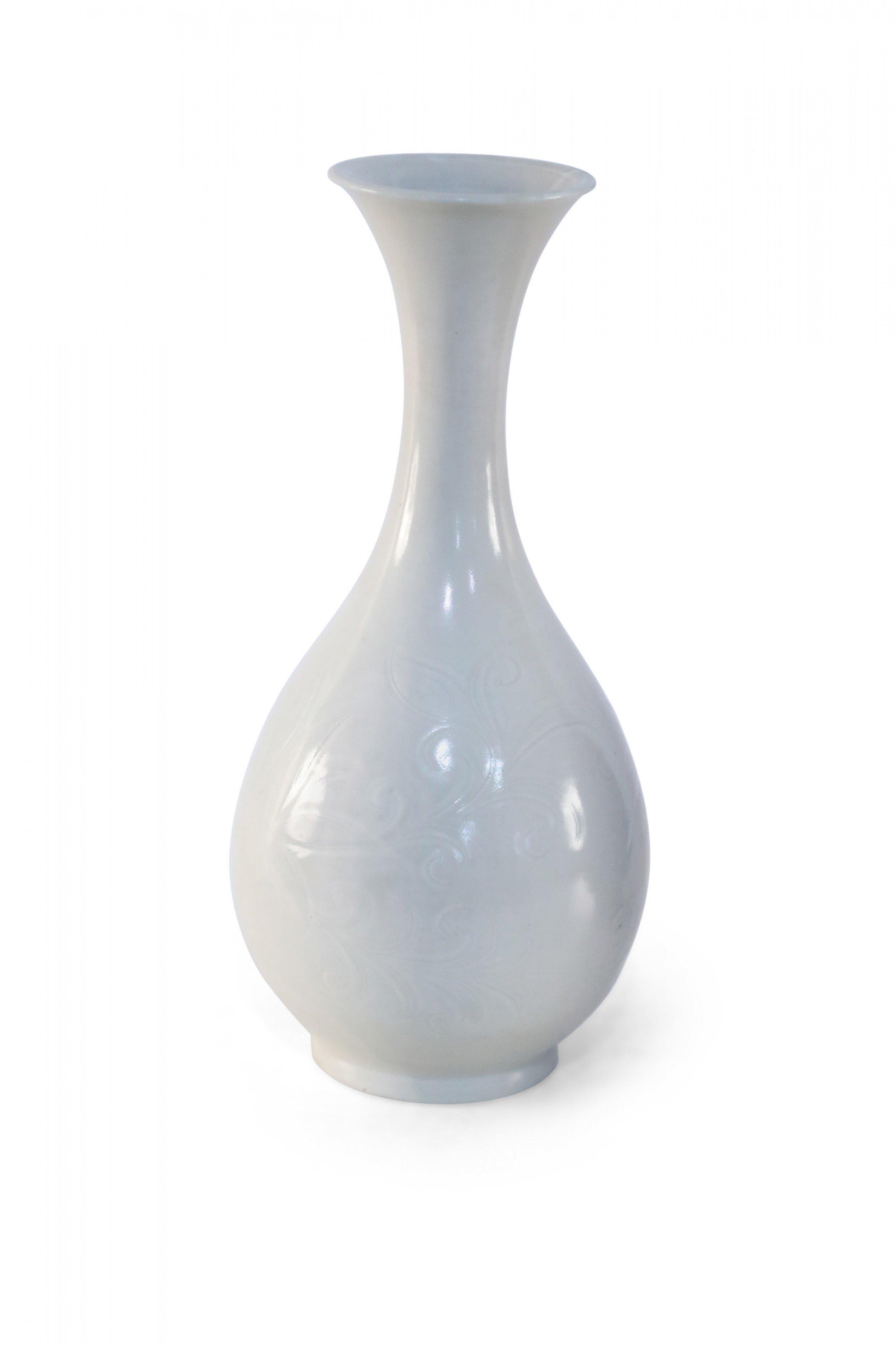 Chinese off-white porcelain vase with a pear shape carved in a tonal, scrolling botanical pattern (date mark on bottom, see photos).
 