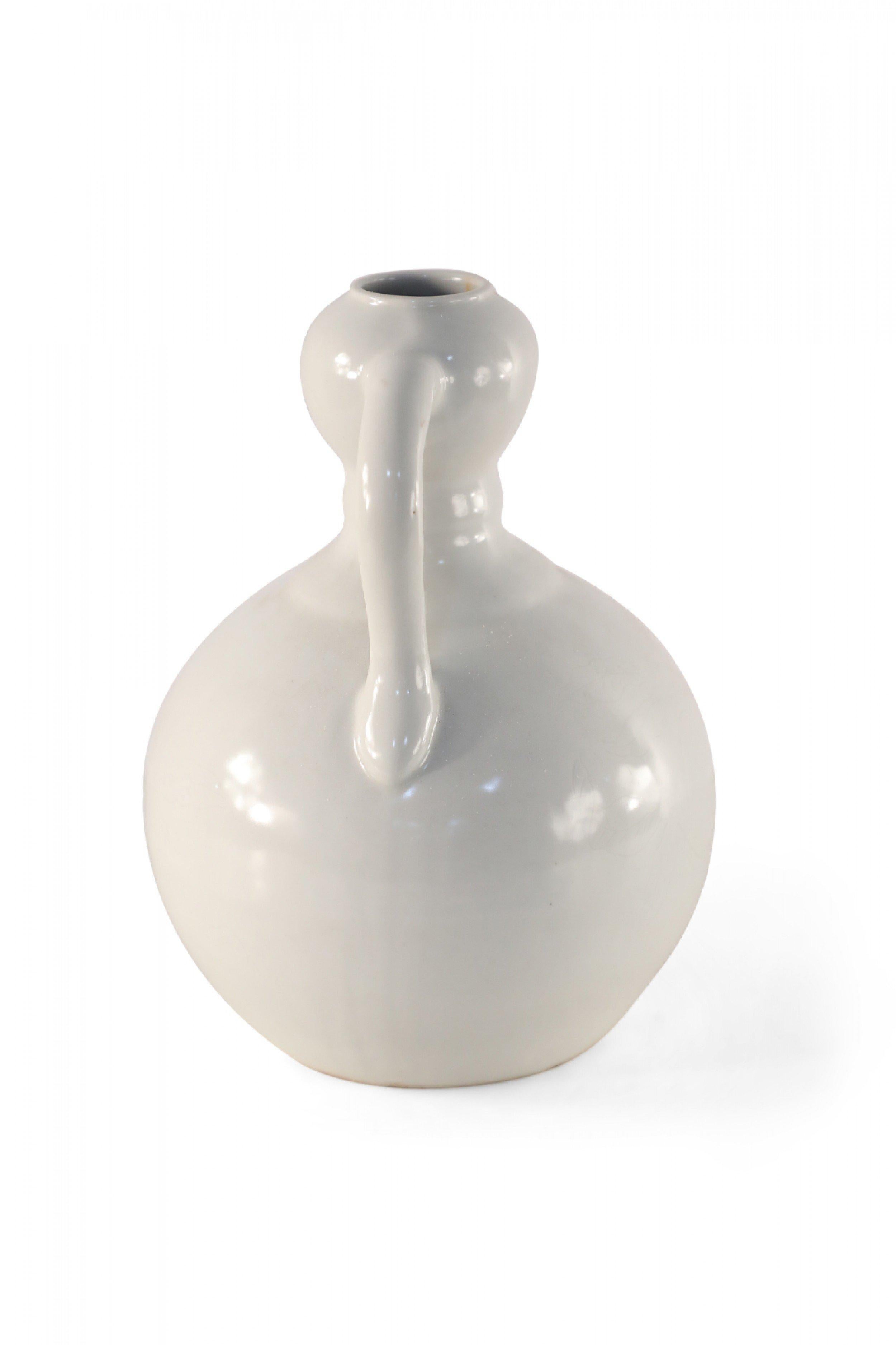 Chinese off-white porcelain, gourd-shaped double ear vase decorated in highly subtle tonal lemons, swirling clouds and writing, and accented with two shouldered handles connecting the top and bottom (date mark on bottom).