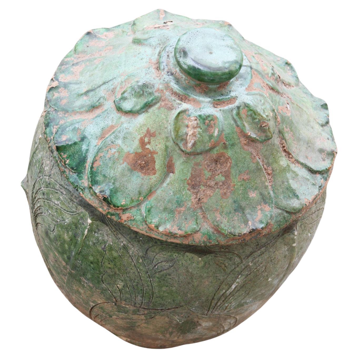 Chinese offering Pot from the Yuan Dynasty

Probably used to contain ritual offerings, this jar may have come from a Buddhist temple or shrine. Decorated with circular geometrical shapes & lotus design this offering jar is adorned with a green glaze