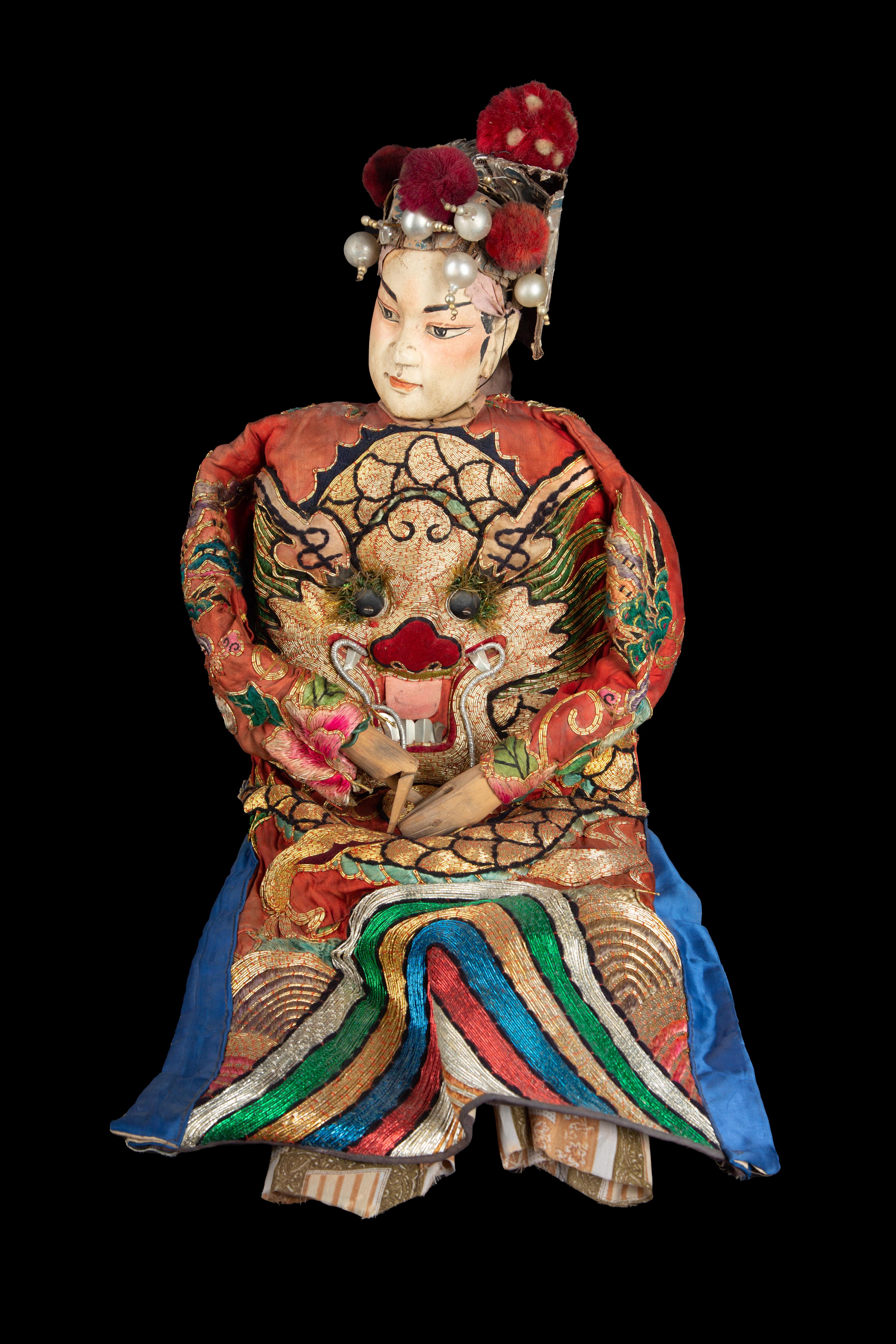 Chinese opera marionette male doll, circa 1920s. The head of this puppet is carved in a soft wood; the feet and hands are also made of wood. The hands can form a closed fist or an open palm by the joint at the level of the fingers. The headdress of