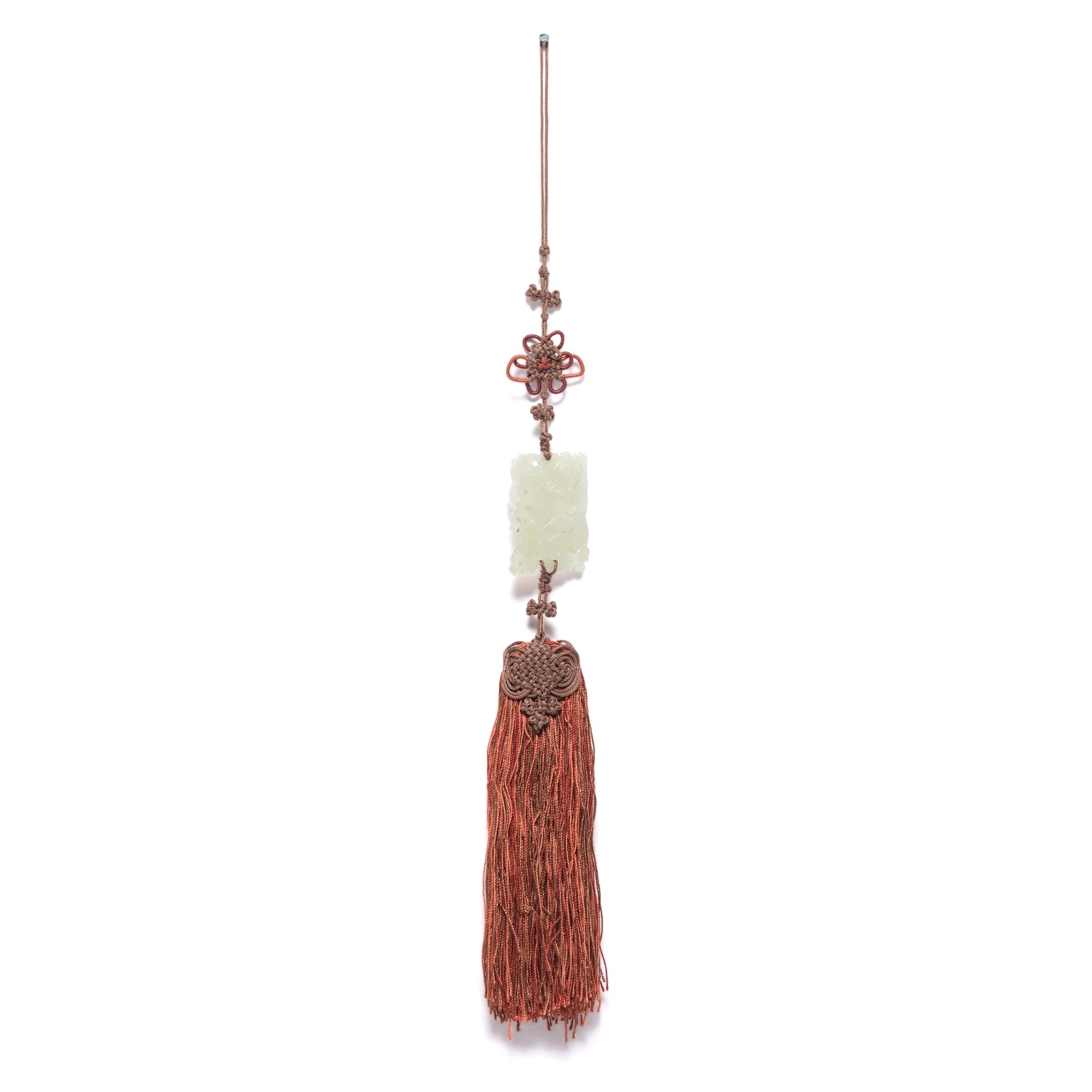 A Chinese knot is tied from a single length of cord carefully woven into a variety of complex shapes, the knots end in tassels, which are used to add elegance to everyday items like hairpins or lanterns. This handmade orange silk tassel is knotted