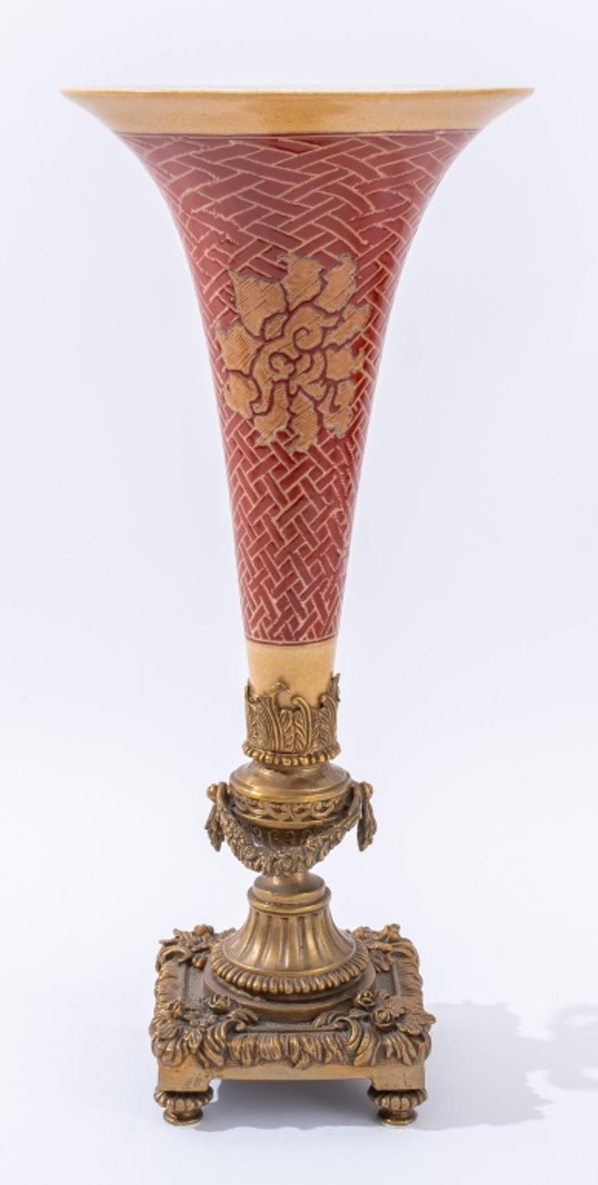 Set of two Chinese porcelain centerpieces comprising (1) one red and beige vase with French Louis XVI style ormolu mounts and (1) one red and beige bowl with French Louis XV style ormolu mounts, two handles, raised on paw feet, both with identical