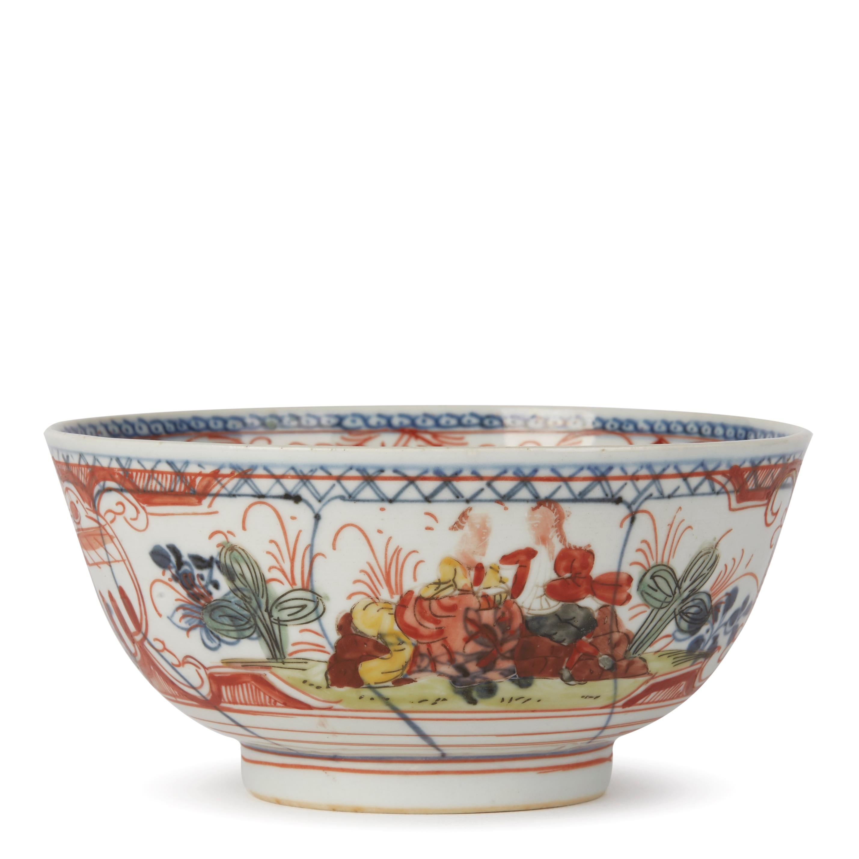 An unusual antique Chinese early Qianlong, or earlier, porcelain bowl, probably Dutch decorated with underglaze blue panels containing floral designs and over painted with seated figures on rockwork and with a figure on a ladder picking fruit