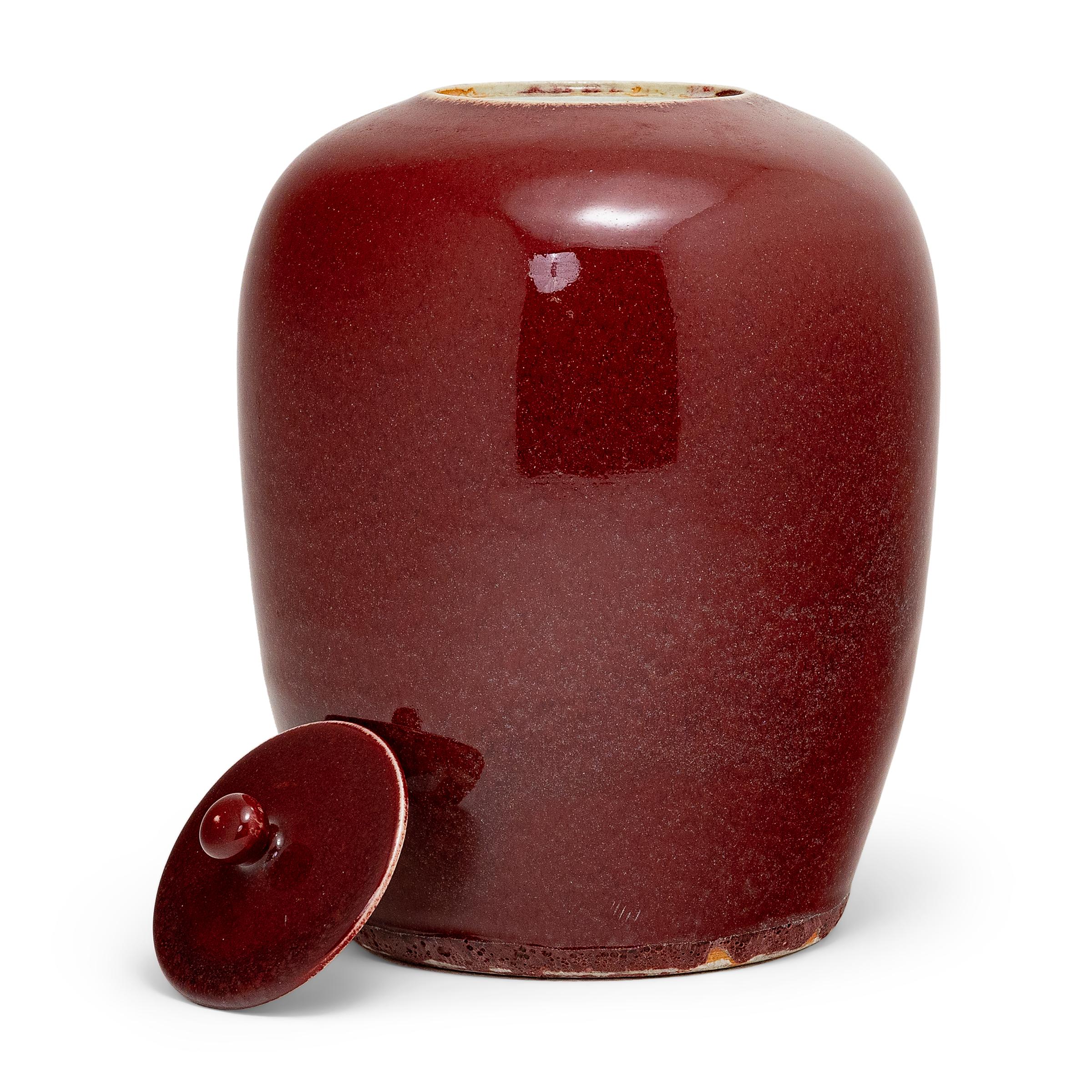 This tapered, ovoid ginger jar harkens back to the Song Dynasty (960 to 1279 AD) when artisans perfected the art of monochrome glazes. The vase's deep, rich red glaze is often called 