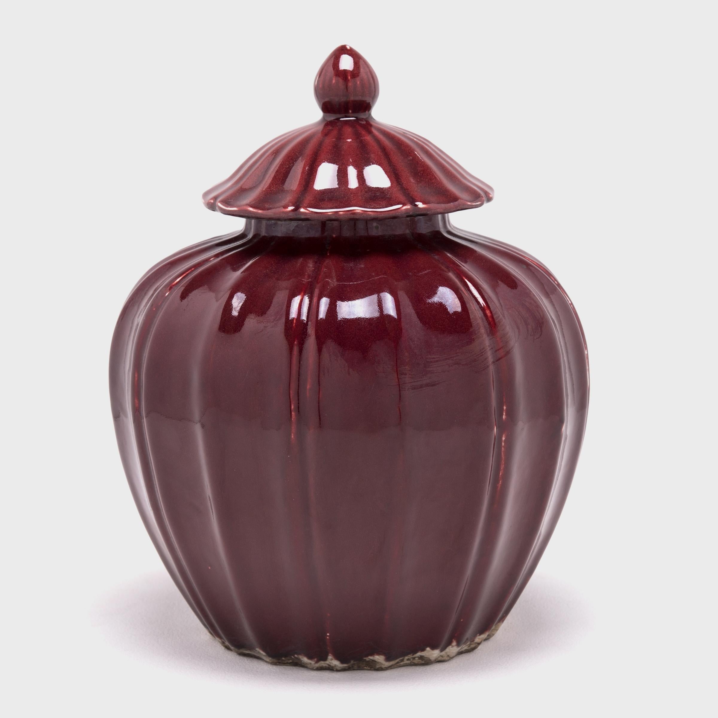 The melon shape is respected by the Chinese not only as a form but as a symbol for proliferation. These contemporary ceramics call back to the Song dynasty when artisans focused their efforts on the art of monochrome glazes. The vase's deep, rich