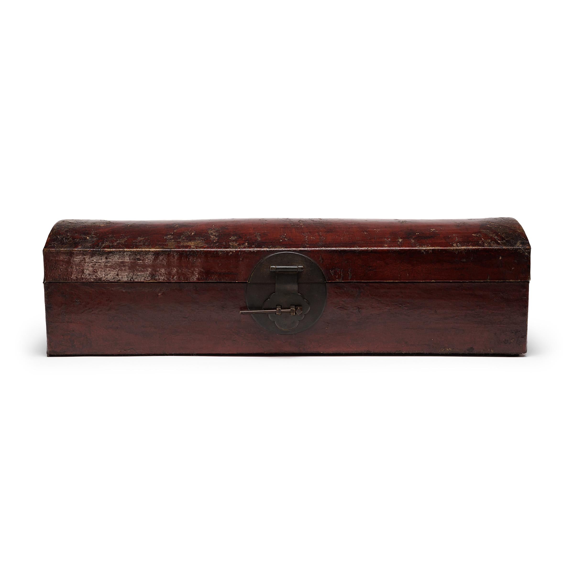 This 19th-century document box once sat amidst the erudite treasures of a Qing-dynasty scholars' studio. The perfect size for a rolled-up scroll, the box would have been used to store and protect works of fine calligraphy and traditional landscape