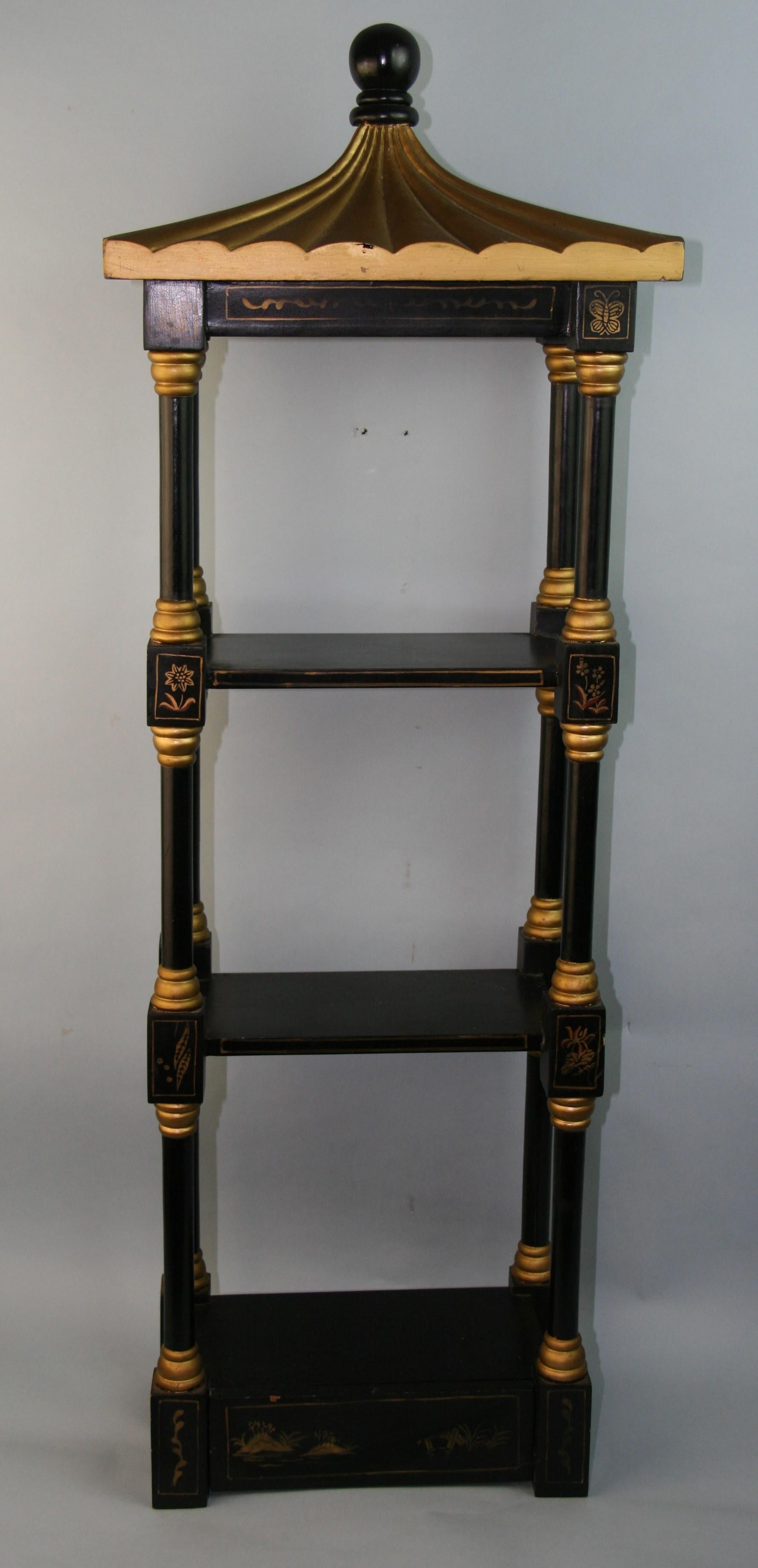 1137 Chinoiserie pagoda three tier wall shelf.
Black lacquer with gilt detail. One drawer on bottom
Ready to hang or can stand securely.