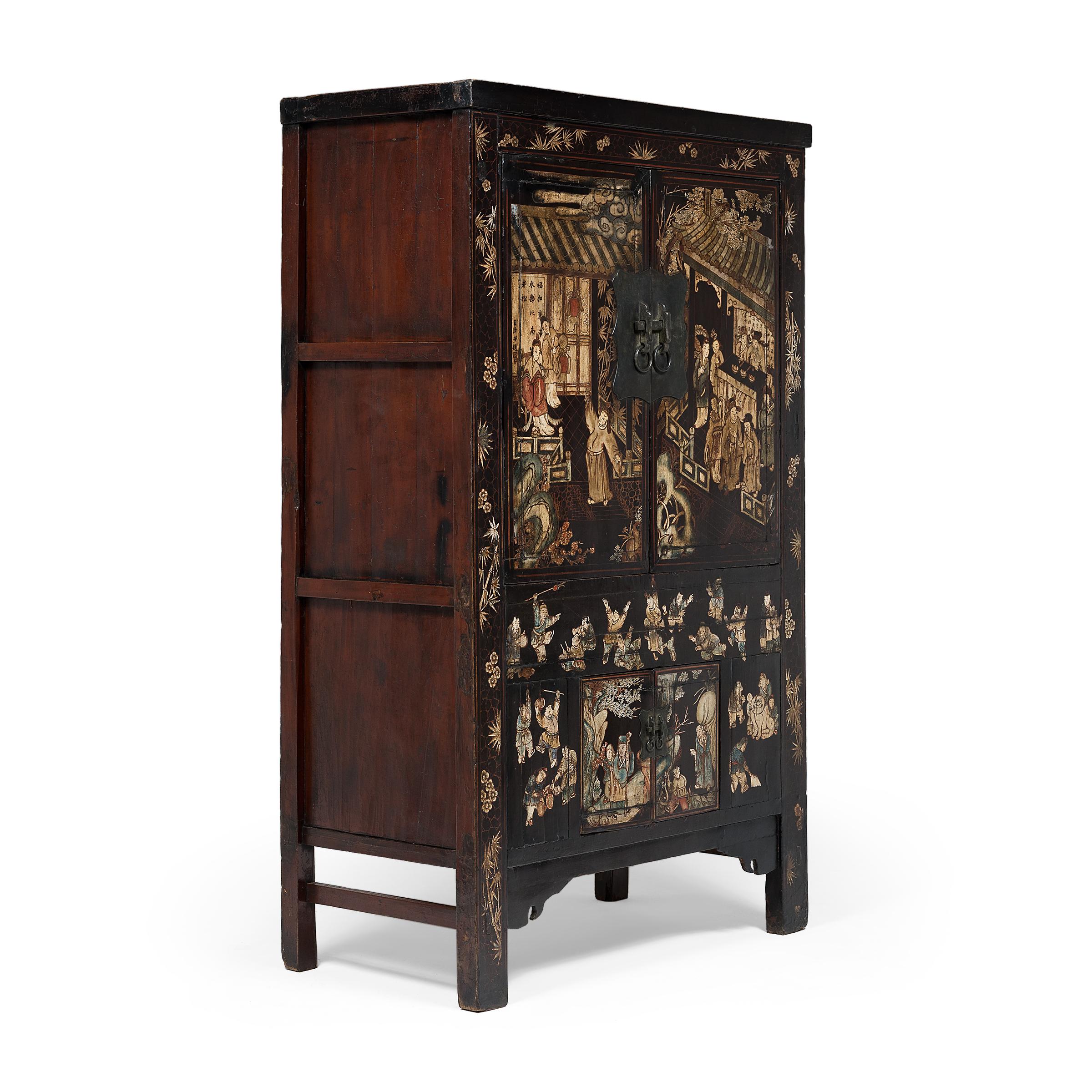 Constructed with four doors, this spectacular Qing-dynasty cabinet from the mid-19th century is lavishly painted with scenes of courtly life in a grand palace garden. Seamlessly constructed and darkly lacquered, the tall cabinet provides the perfect
