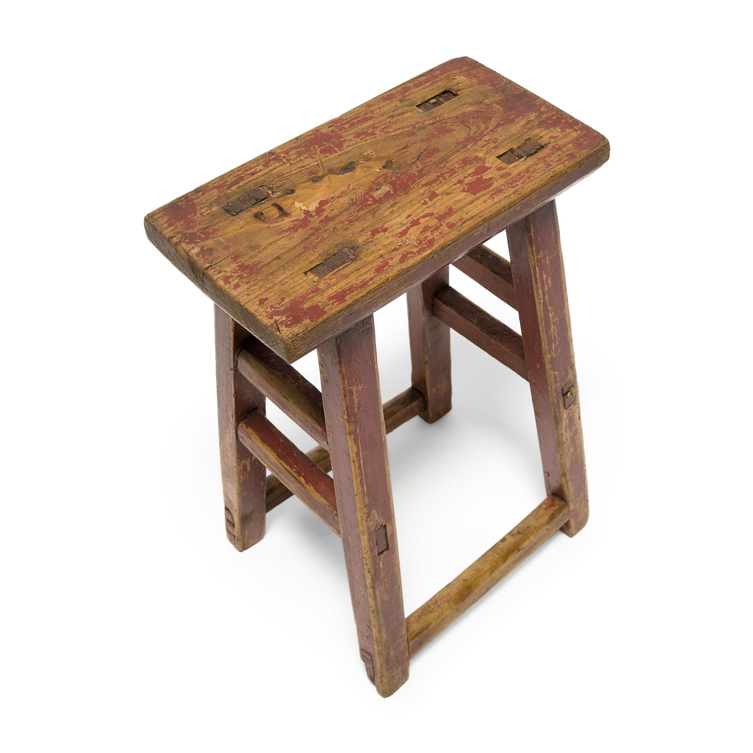 Deceptively simple, this early 20th century stool from Shanxi province shows off the ingenious mortise-and-tenon joinery methods traditionally used by Chinese carpenters. The stool has a rectangular seat supported by four splayed legs linked with