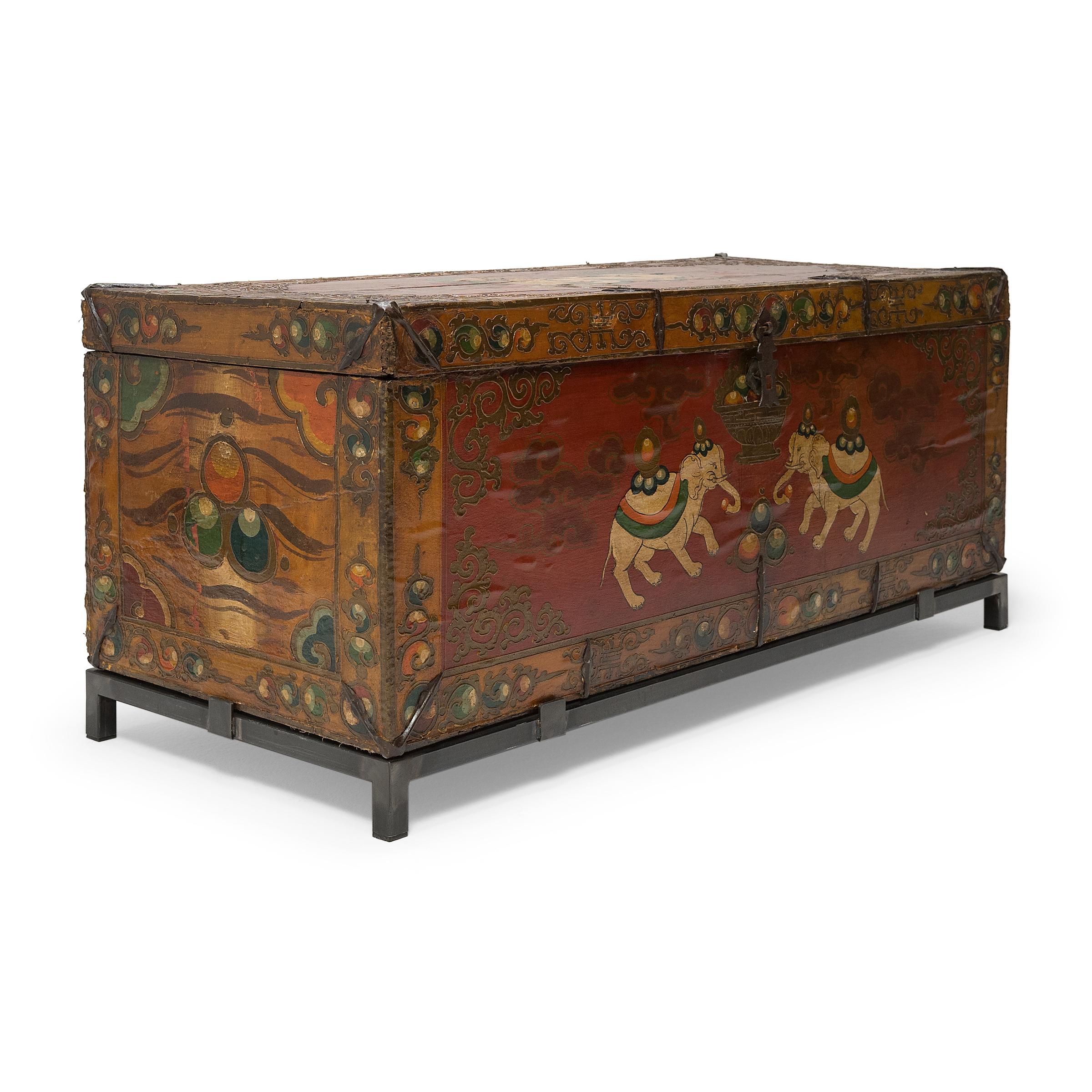 This fantastic painted trunk from northern China is lavishly decorated from end to end in the Tibetan style with a rich palette of red, orange, and green. Raised outlines and layers of glossy lacquer lend the chest rich texture and catch the light