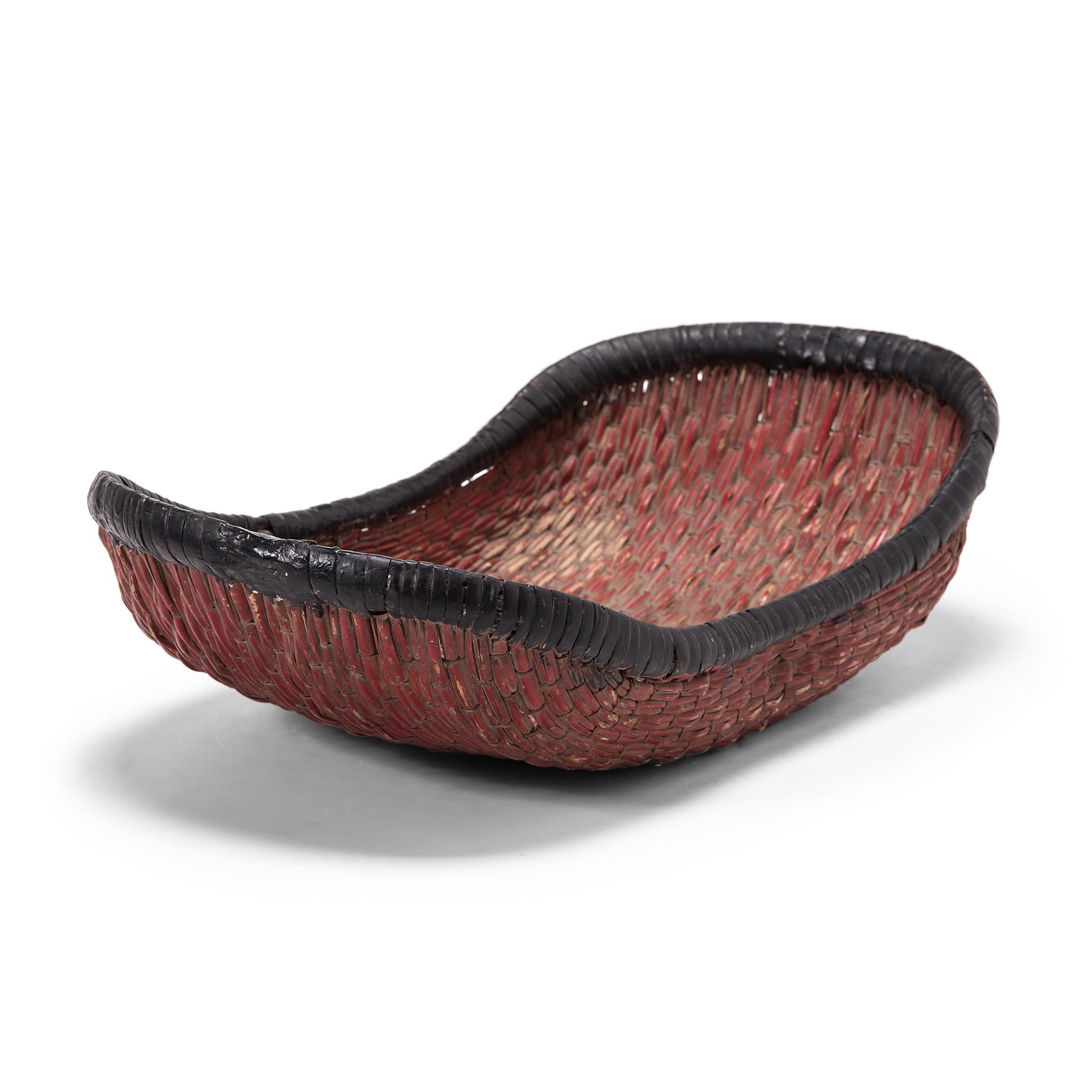 Woven with a delightfully unusual form, this early 20th century basket was originally used to steam mantou buns in a provincial home in Shanxi province. The boat-shaped basket is formed of willow reeds entwined with a plain weave, and has since been