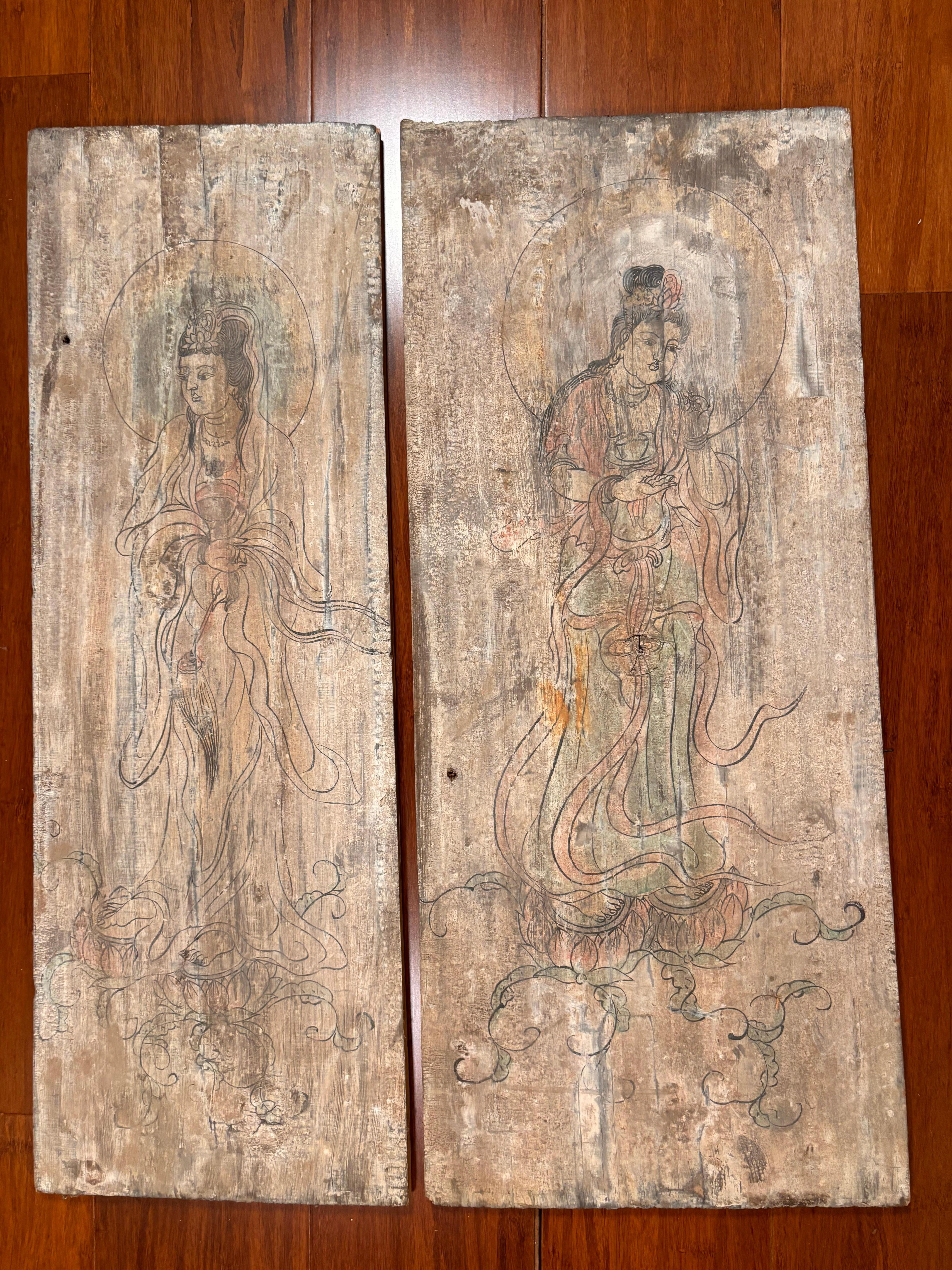 A wonderful Chinese hand painted pair (2) paintings on old wooden panels of  Buddhist Bodhisattvas in  attractive poses with crown mandorla and long flowing robes.  Frame them or mount as is.

One of a kind pair.

Provenance: Private New England