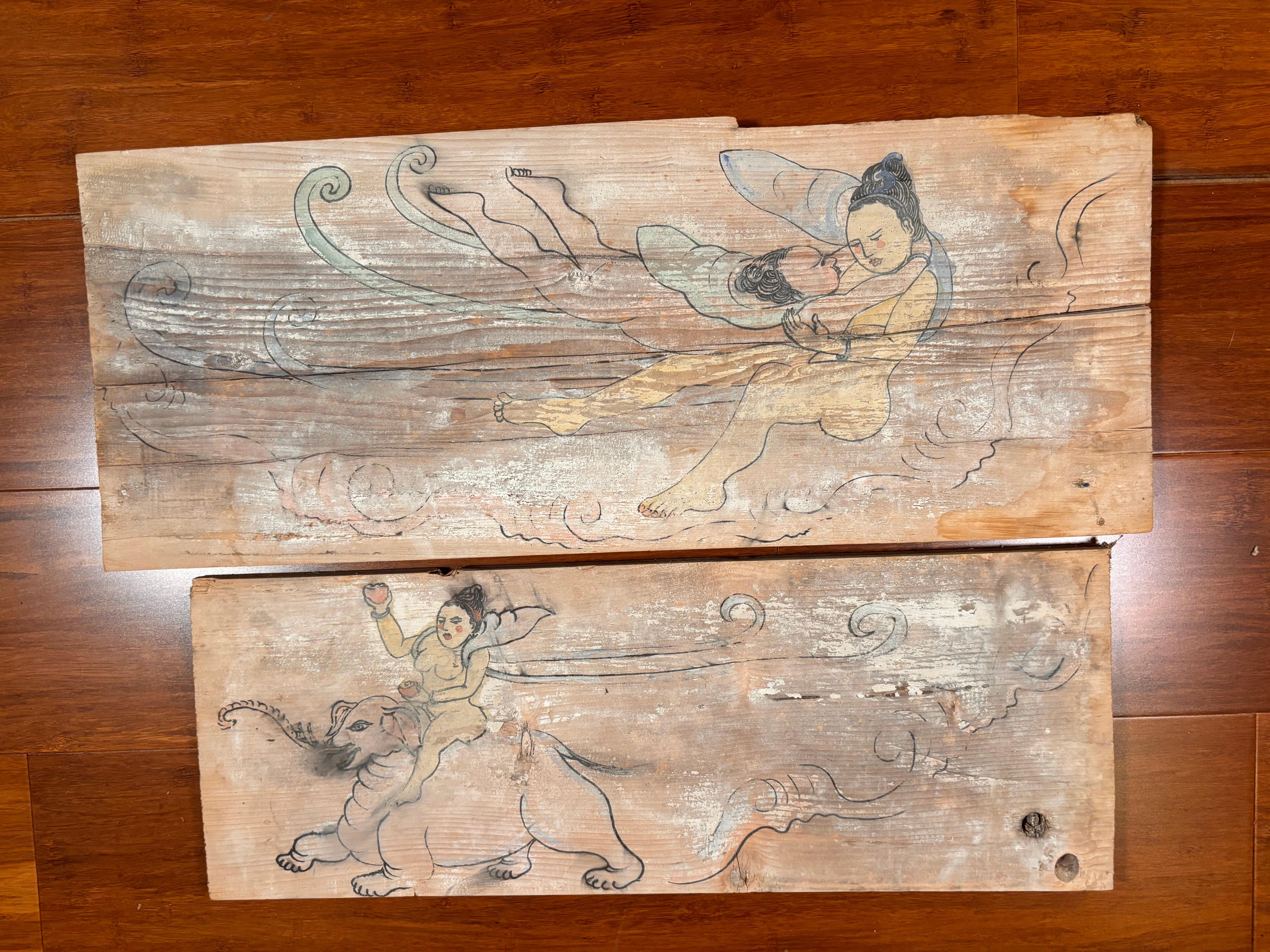 A wonderful Chinese hand painted pair (2) paintings on old wooden panels of  Buddhist Bodhisattvas in  amorous  poses with child and elephant presence and long flowing robes.  Frame them or mount as is.

One of a kind pair.  Larger panel is 8 inches