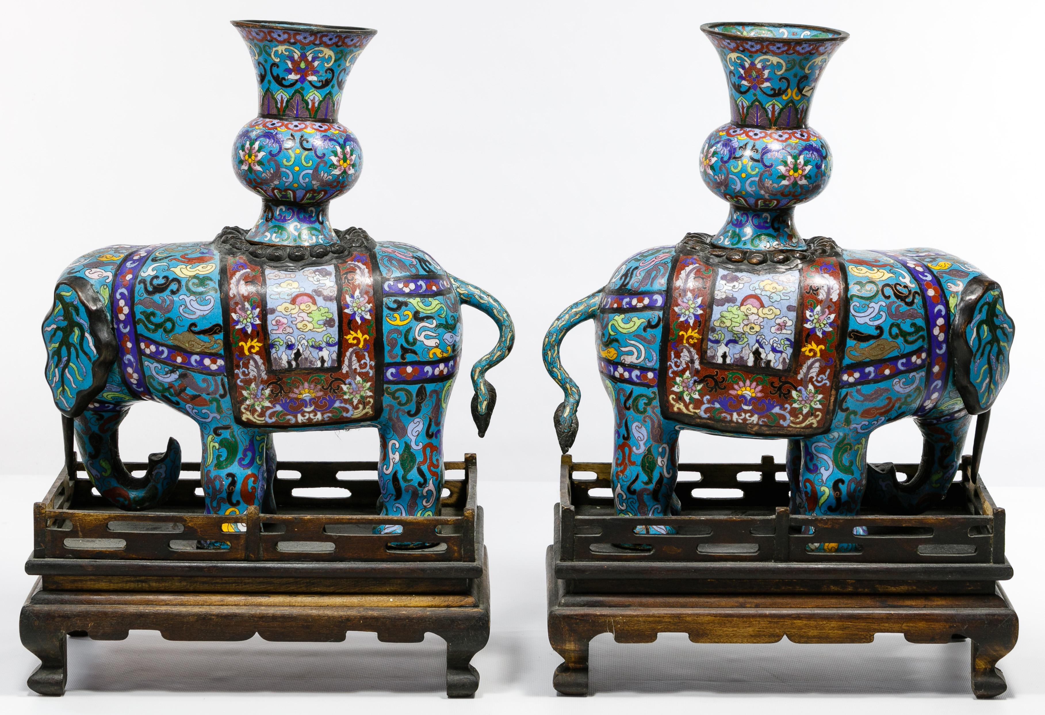 Large pair of standing elephants having fitted vases on their backs on wooden display stands
Measures: Height: 15 inches, Length: 14 inches, Width: 6 inches (without stands), Total Height with stand: 20.5
