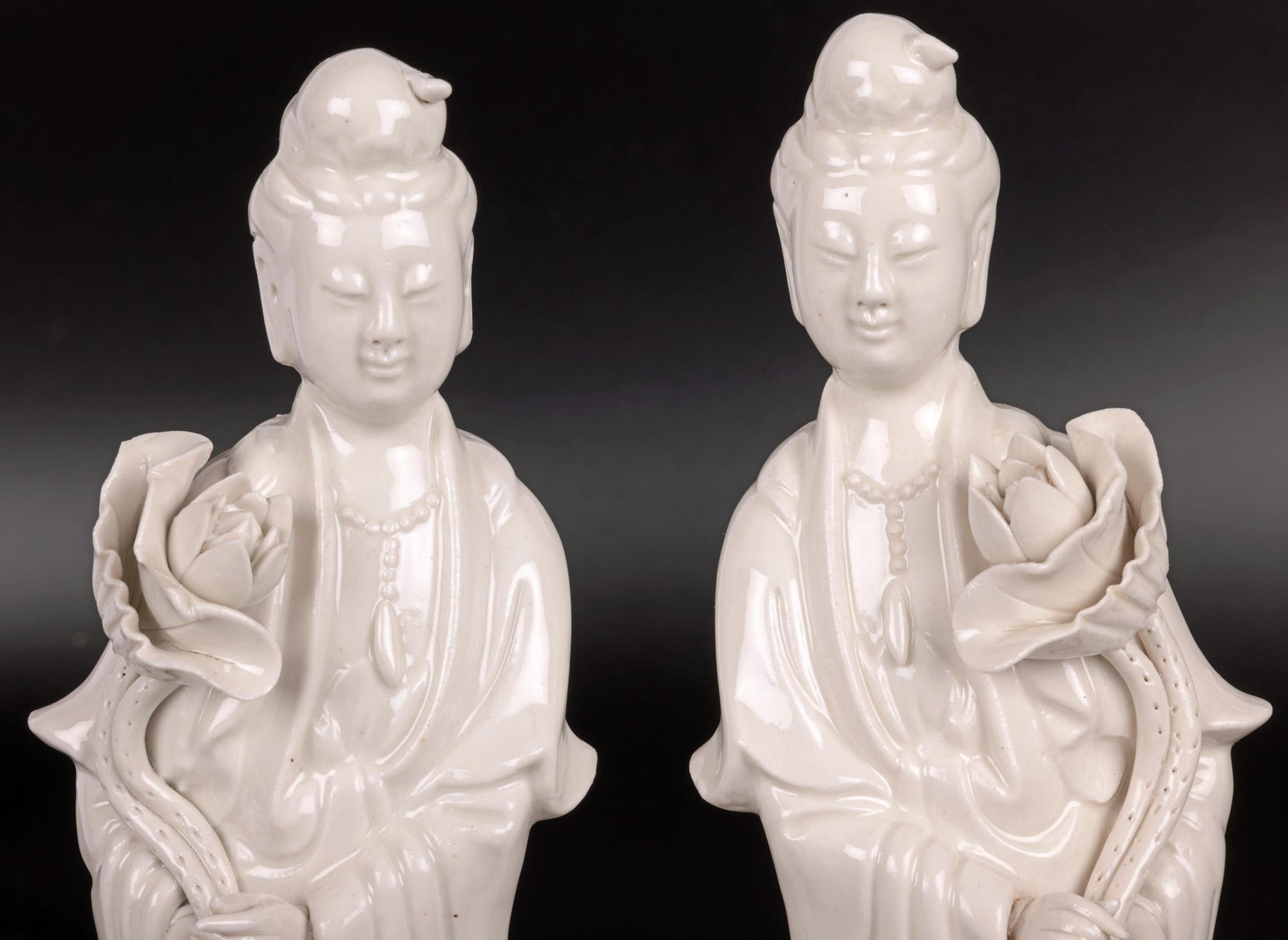 A fine pair vintage Chinese porcelain blanc de chine figures of Guanyin dating from the early to mid 20th century. The hollow formed figures portray Guanyin standing on a circular pedestal base adorned with trailing lotus flowers on leafy stems and