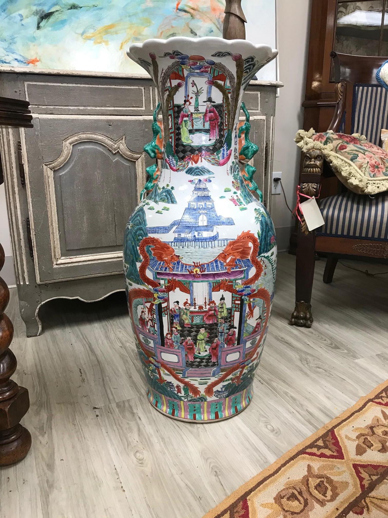 Palace style vase with scenes of both palace and wealth/good fortune. The neck of the vase is adorned with lion and lion cub handles, adding more detail to the vase and scenes.