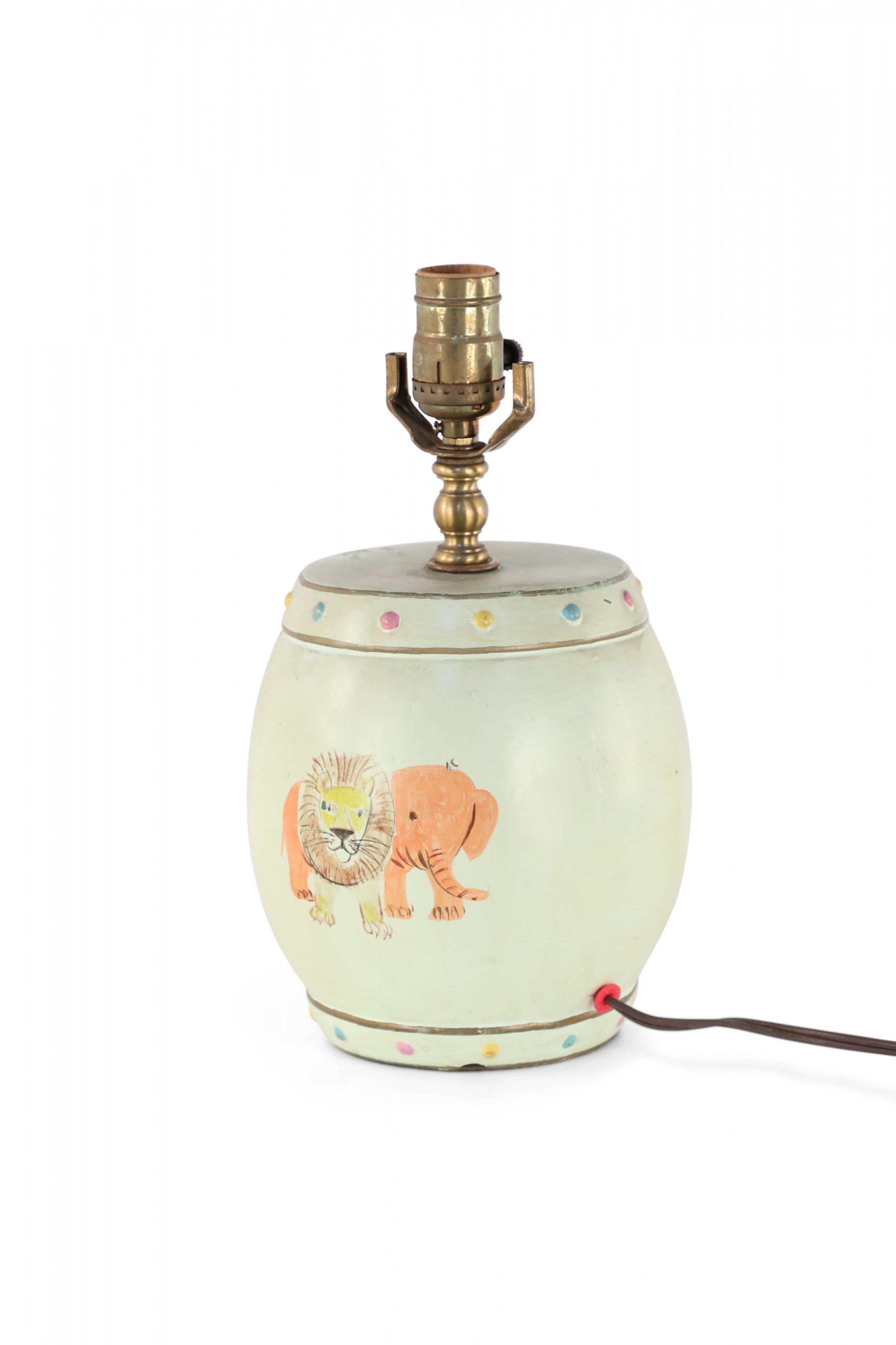 Chinese porcelain table lamp made from a pale green, barrel shaped vase painted with a joyful scene of a child on a horse and a lion and elephant on the reverse side, finished with brass hardware.
 