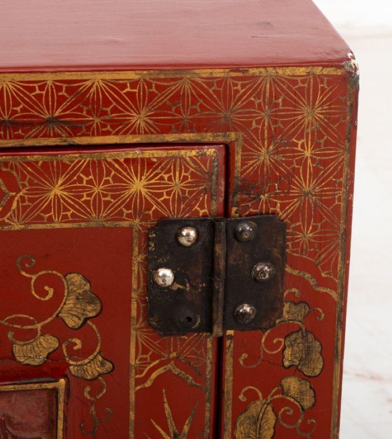 Chinese parcel gilt red lacquer cabinet, the doors centered with carved panels with auspicious dragons in a landscape, the sides with Chinoiserie scenes. Provenance: Property from the Fifth Avenue residence of the MacArthur Family. 

Dealer: S138XX