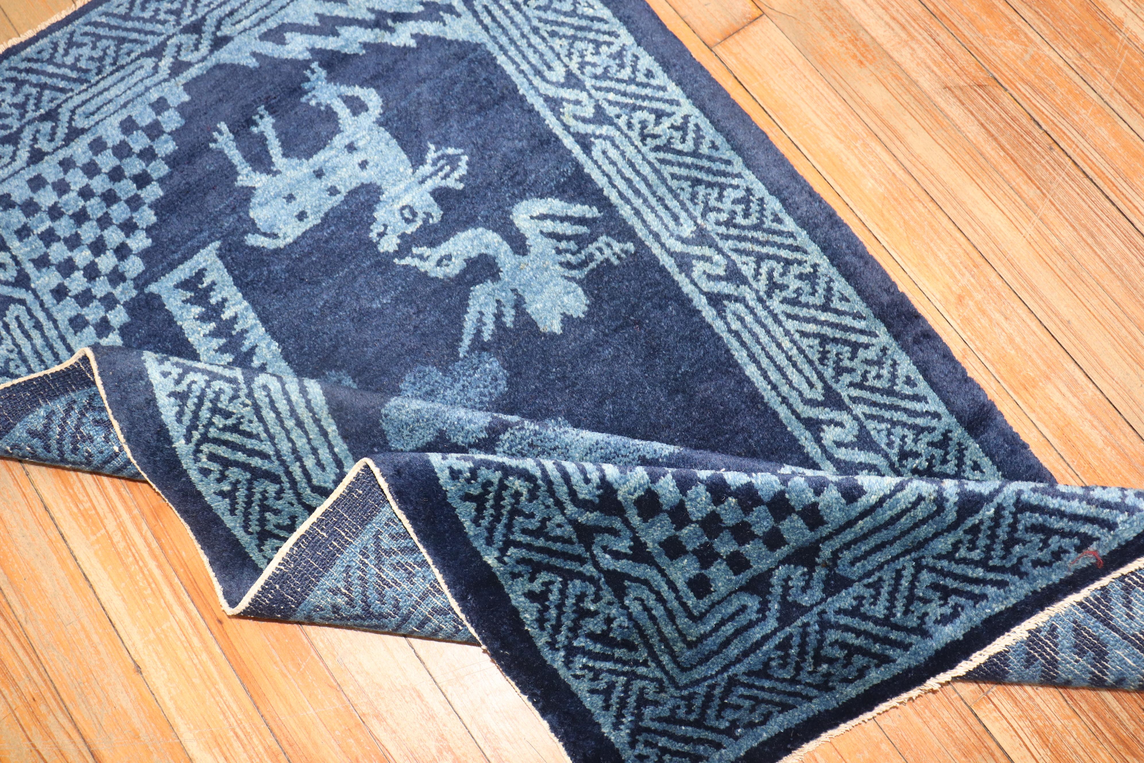A Chinese peking carpet in midnight blue with a pictorial animal motif.

Measures: 2'3'' x 4'.