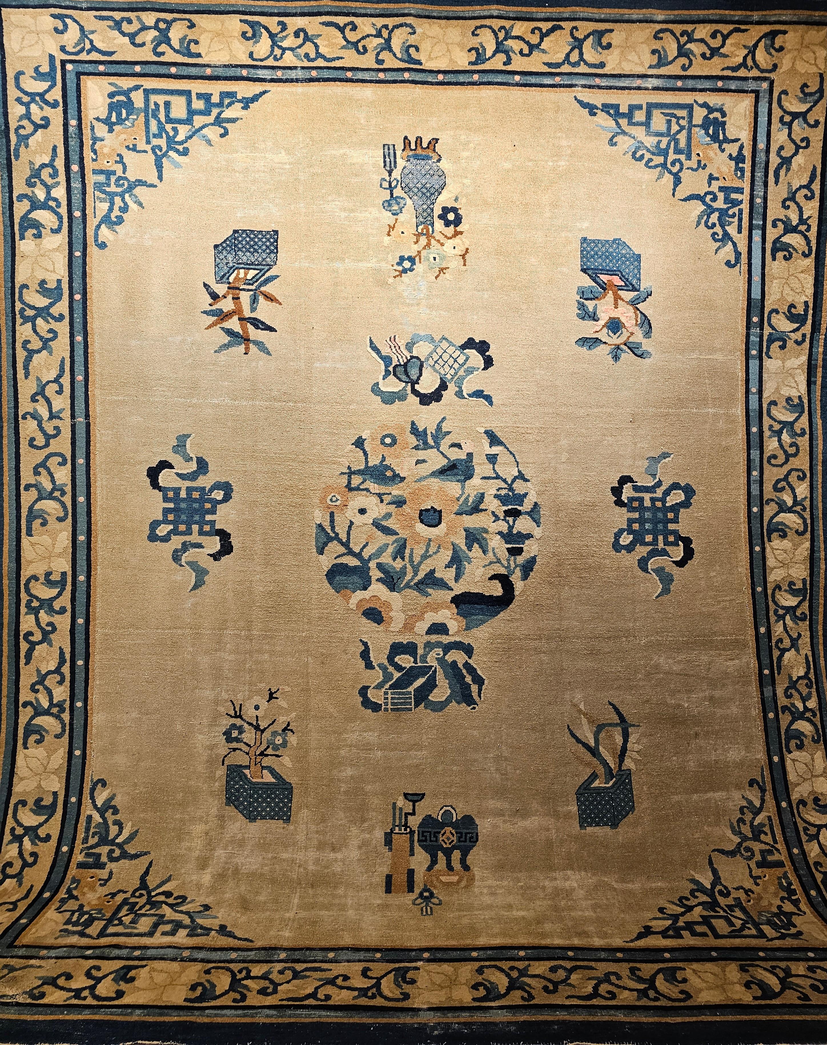 Vintage Chinese Peking in a “near square” size with symbols for fortune, prosperity, and long life from the 4th quarter of the 1800s. The rug has a very unique and beautiful wheat field color with French blue and navy blue Designs. The design in the