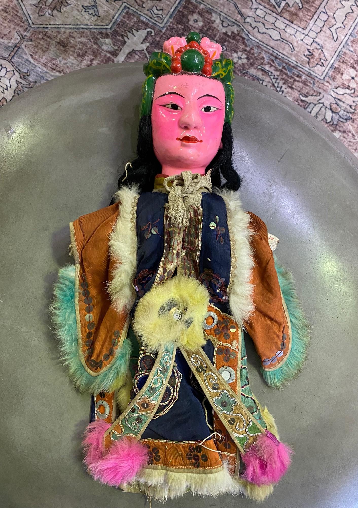 A wonderful work complete with a unique wood-carved and hand-painted face and original textile garment. 

From a group of 7 Chinese opera puppets, we acquired from a collector. Each puppet shows clear signs of previous stage use.

Likely from