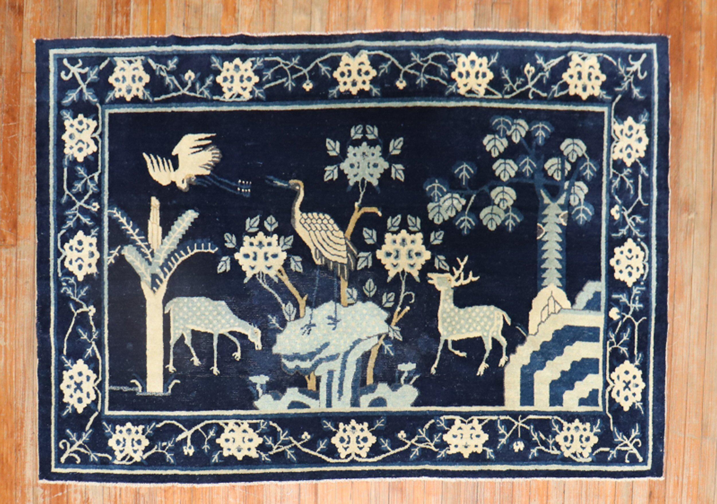 An early 20th Century Chinese rug with an animal motif on a navy field

Measures: 4'4'' x 6'10''.