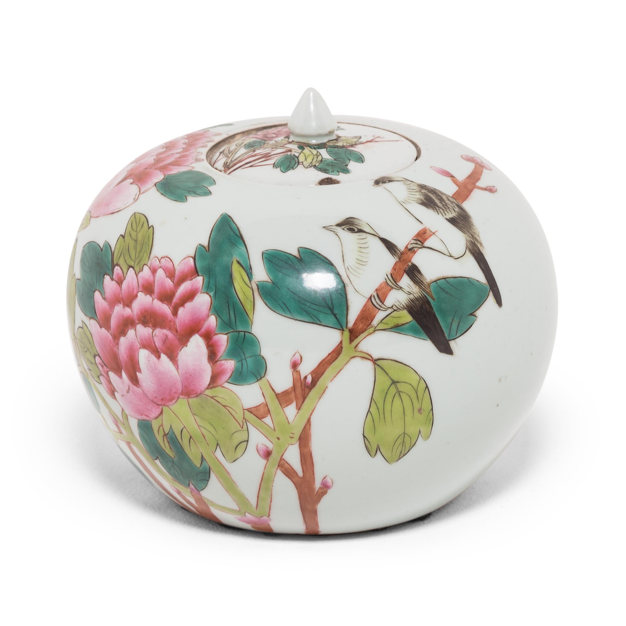 This early 20th century ginger jar features rounded sides and high shoulders that curve in towards a narrow mouth. Painted with expressive brushwork, the jar is festooned with pink peony blossoms, emblems of springtime, love, and affection. Two
