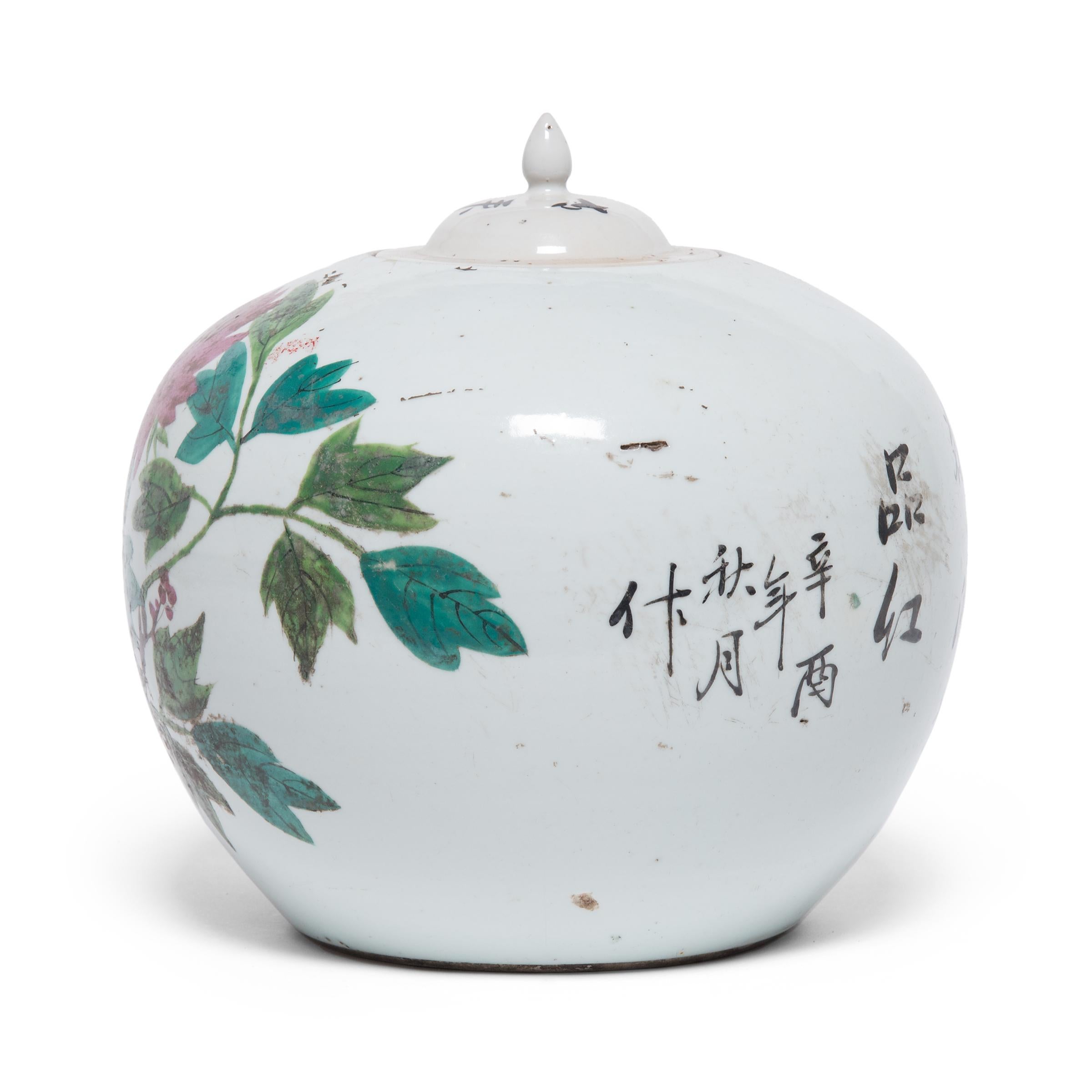 This ginger jar dates to the early 20th century and features rounded sides and high shoulders that curve in towards a narrow mouth. Painted with expressive brushwork in a palette of pinks, blues, and greens, the jar is festooned with peony blossoms,