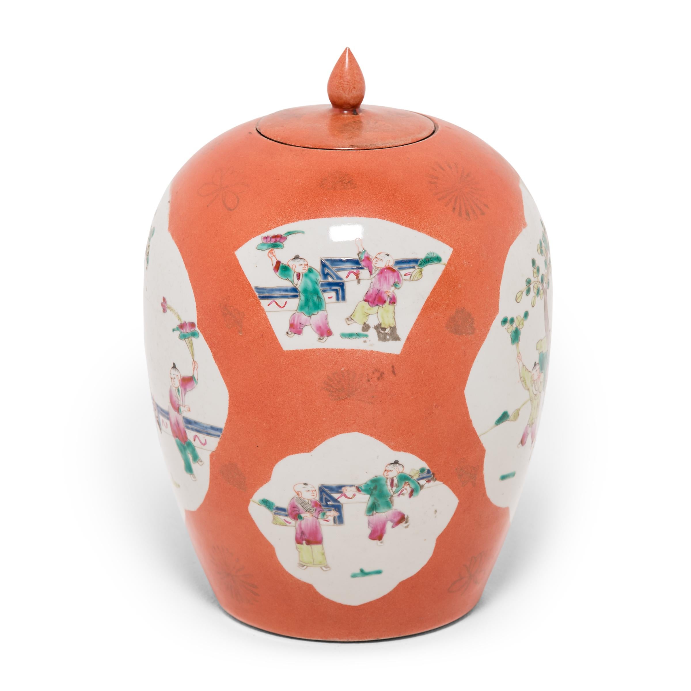 This vase is the perfect example of enduring Chinese symbolism and design. Each side of the ginger jar bears a cartouche painting containing a picturesque scene. Attendants watch over young boys playing in a traditional garden, holding lotus