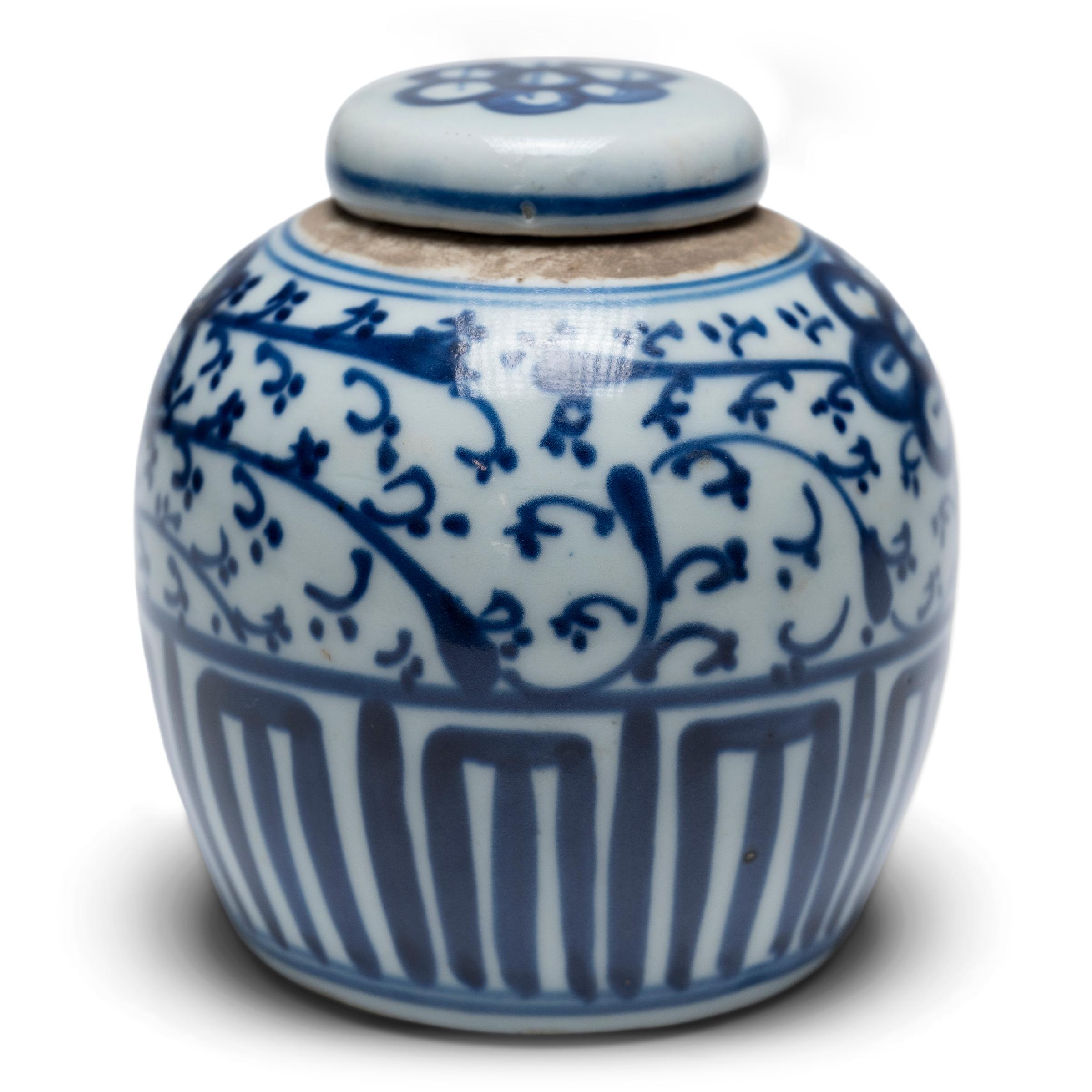 Glazed in the classic blue-and-white manner, this petite Chinese ginger jar is the perfect accent to a bookcase or console table. The little jar is hand-painted in dark, cobalt-blue pigments with an all-over pattern of flowers and trailing vines