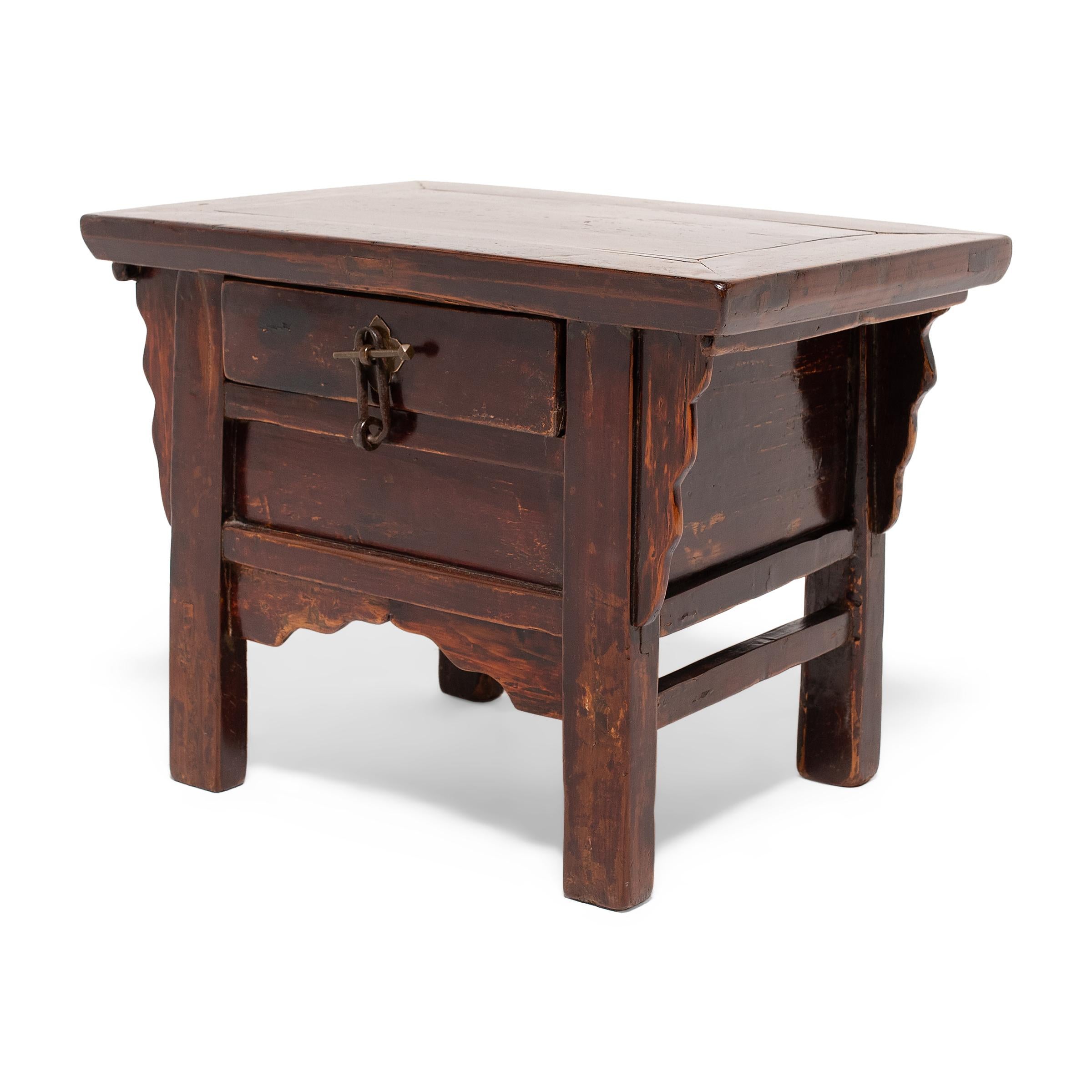 Perfectly proportioned for its petite size, this low elmwood chest is the ideal place to stow odds and ends. The charming cabinet has all the features of a traditional Chinese coffer - straight recessed legs, curving spandrels, and a floating-panel