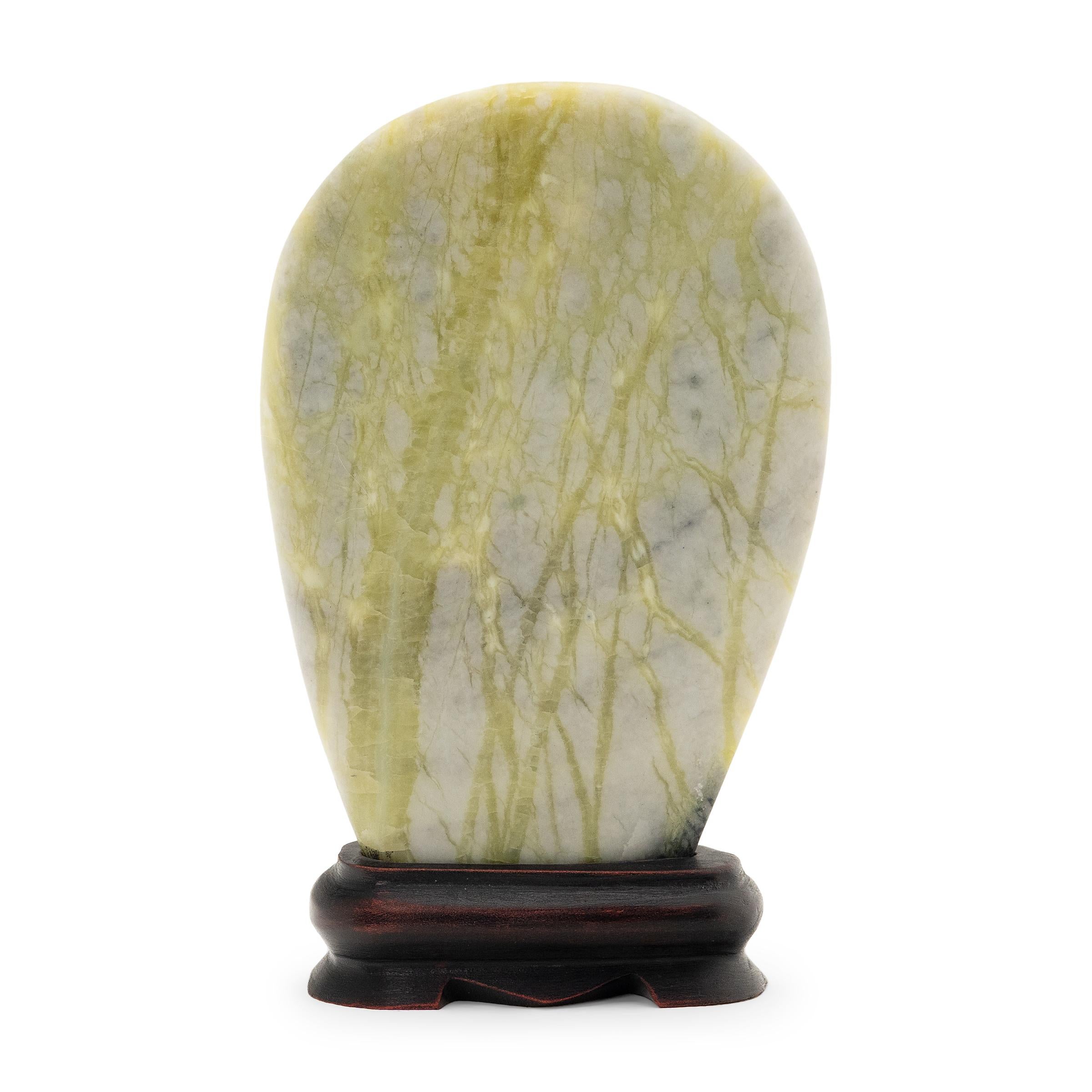 A well-chosen stone is a resting place for the mind, inspiring calm and contemplation. Marked by green and gray currents of jadeite, moss agate, and serpentine, this petite greenery stone evokes the grandeur of nature with beautifully irregular