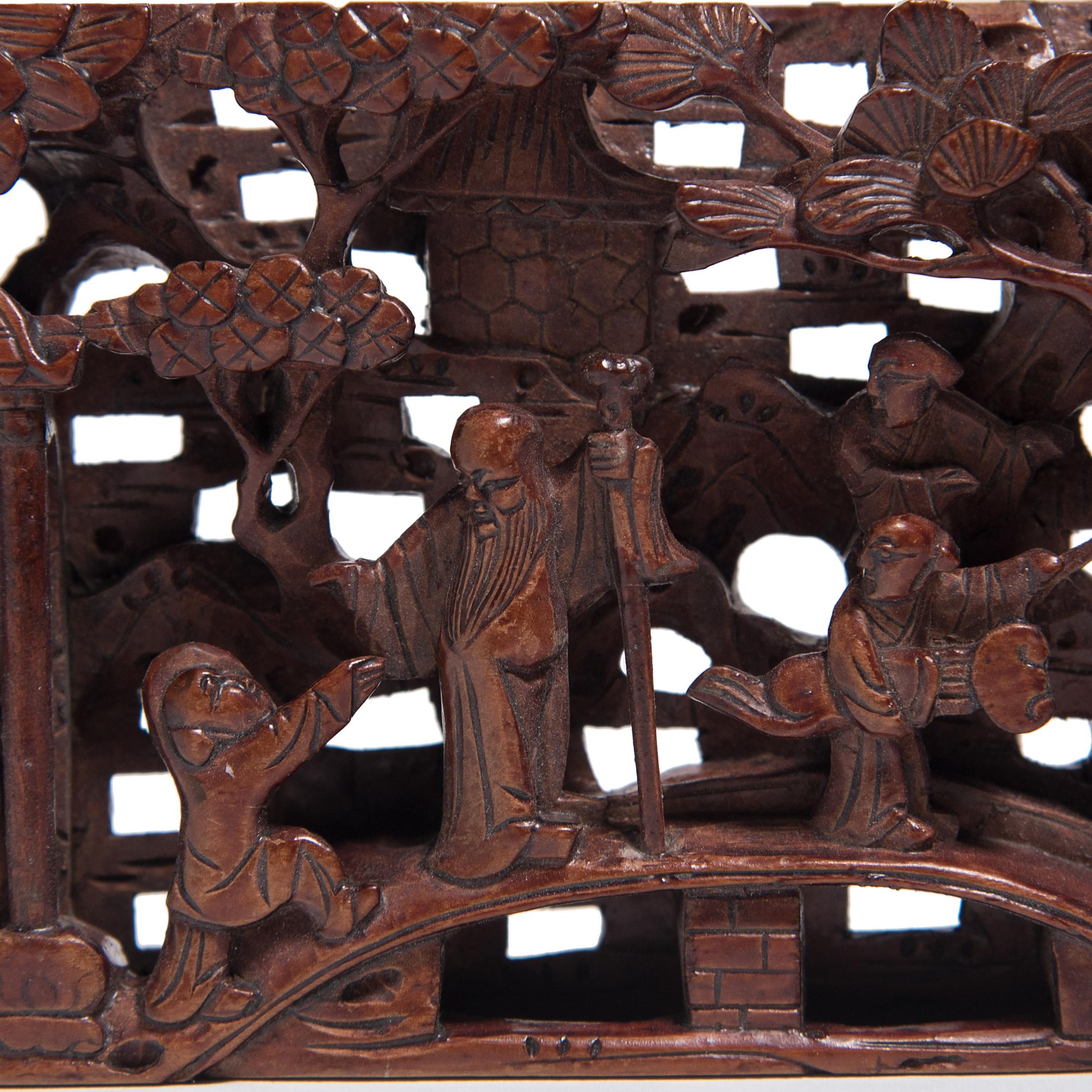 Densely carved with an energetic landscape, this pierced panel was originally inserted to the ornate frame of a 19th century canopy bed. Likely a scene from a Classic Chinese novel, the panel depicts robed officials surrounded by young