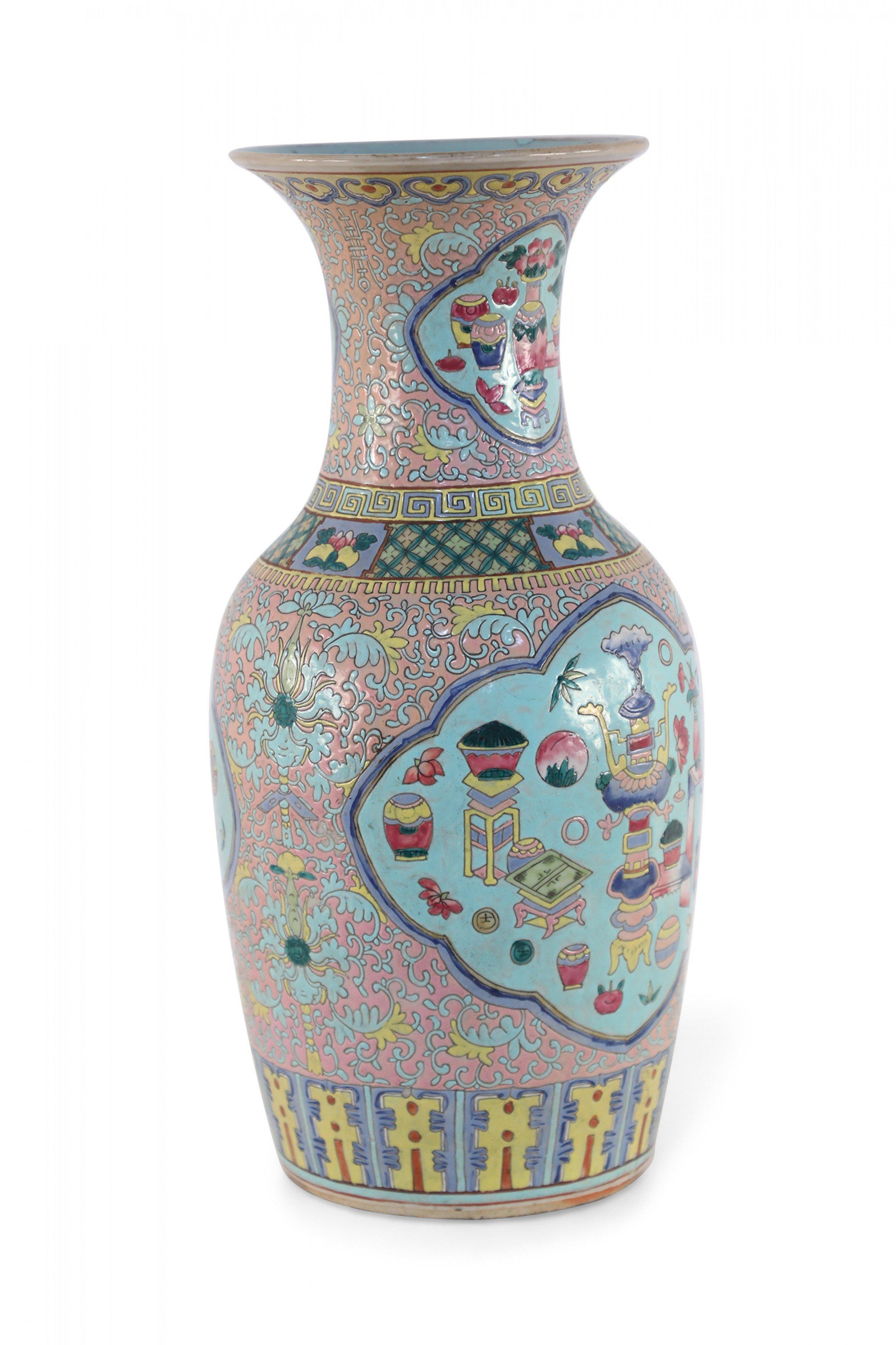 Antique Chinese (late 19th century) pink porcelain urn decorated with a light blue floral design grounding multiple light blue cartouches, each bearing a bogu pattern that signifies elegance and fun.
     