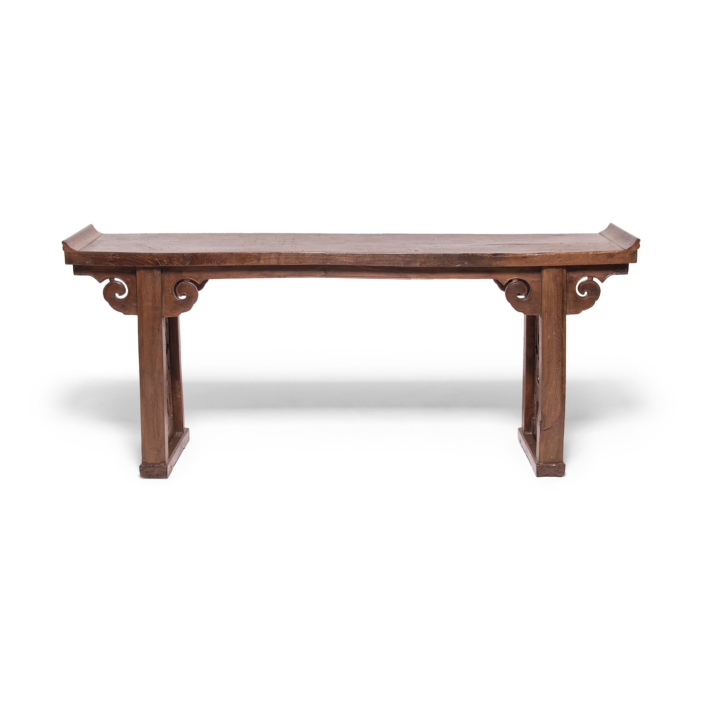 A prime example of Qing-dynasty furniture design, this 19th century table from China's Shanxi province is beautifully proportioned and combines practical considerations with aesthetic principles. Its top is carved from a solid piece of walnut