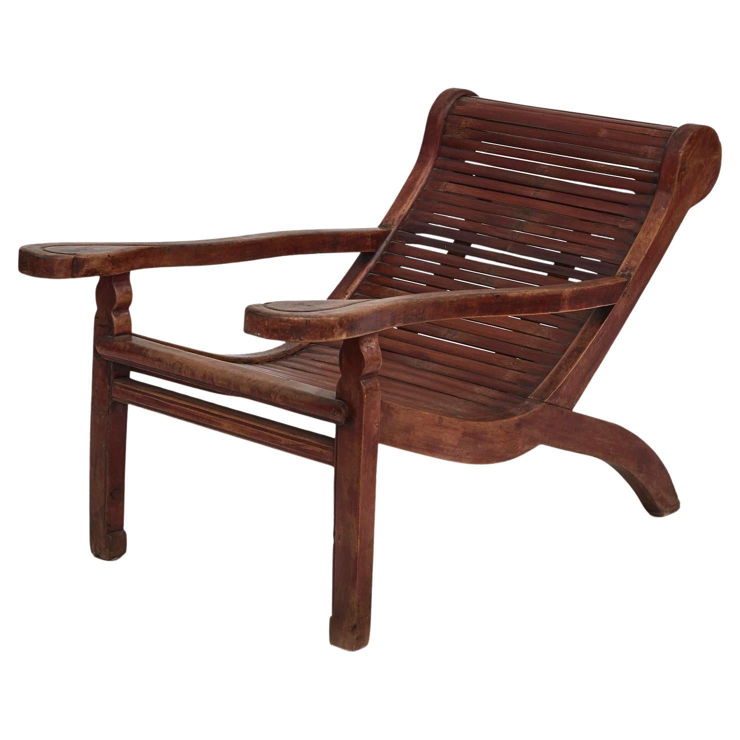 Chinese Plantation Lounge Chair with Curving Seat and Slats For Sale