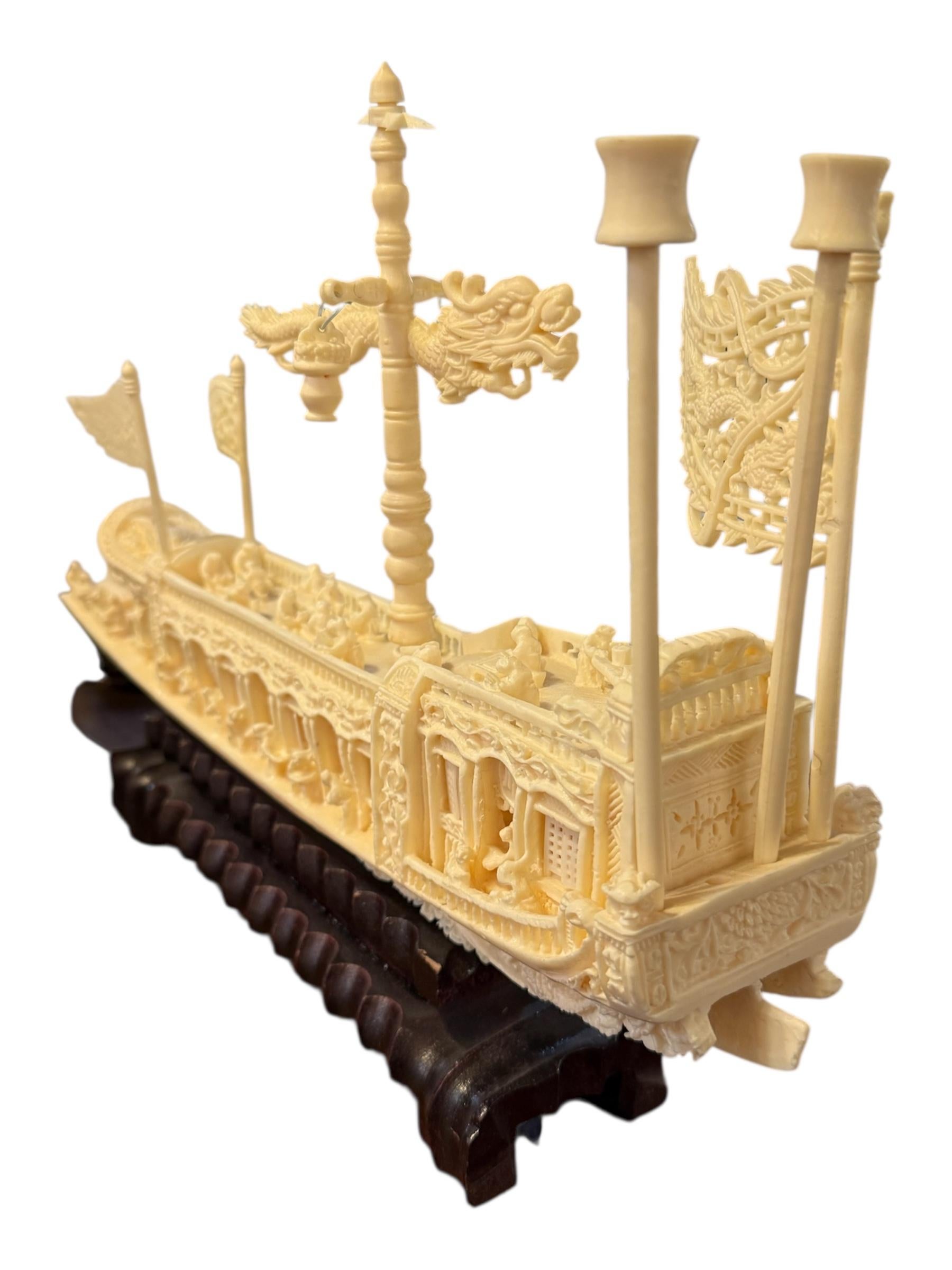 Add an exquisite touch of Eastern craftsmanship to your decor with this Chinese Hand-Carved Ship Boat Figure, a striking representation of traditional Chinese maritime artistry. Beautifully sculpted from ivory-toned plastic to resemble antique ivory