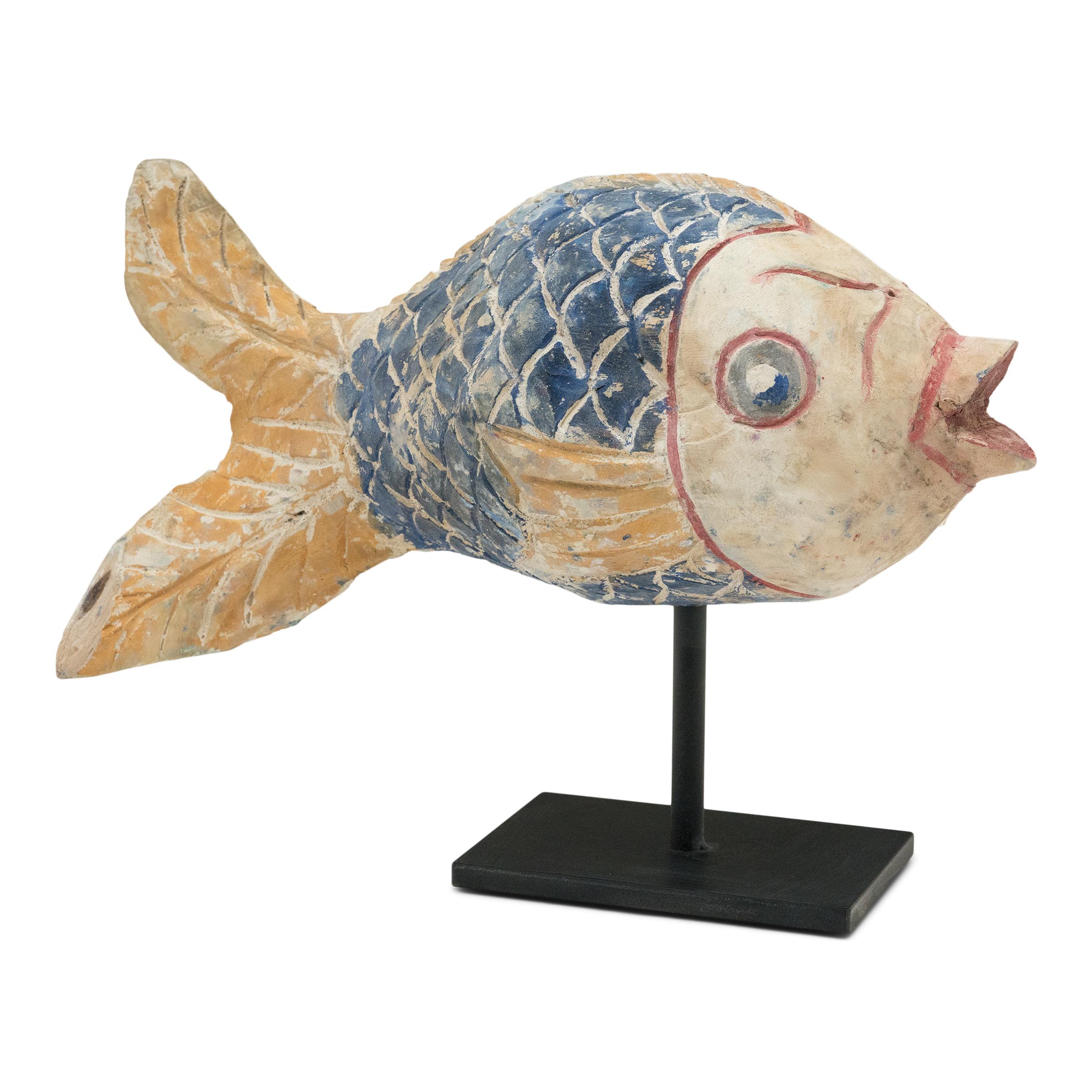 Hand-crafted from reclaimed wood, this large koi sculpture is a traditional symbol of harmony and luck. For Buddhists, such a fish represents a freedom from all restraints. Much of the popularity of fish as a decorative theme hinges on the fact that