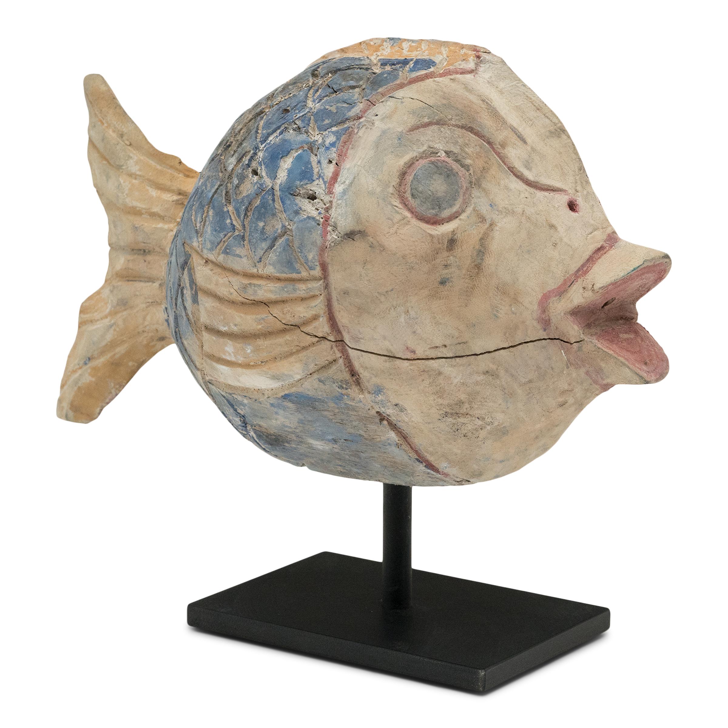 Hand-crafted from reclaimed wood, this large koi sculpture is a traditional symbol of harmony and luck. For Buddhists, such a fish represents a freedom from all restraints. Much of the popularity of fish as a decorative theme hinges on the fact that