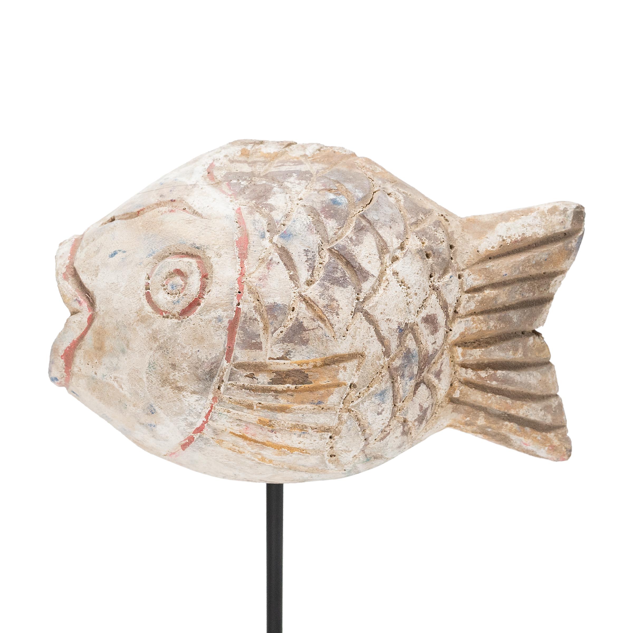 Hand-crafted from reclaimed wood, this artist-made koi is a traditional symbol of harmony and wealth. For Buddhists, such a fish represents a freedom from all restraints. The scales and fins on the squat, rounded body are highlighted with brown,