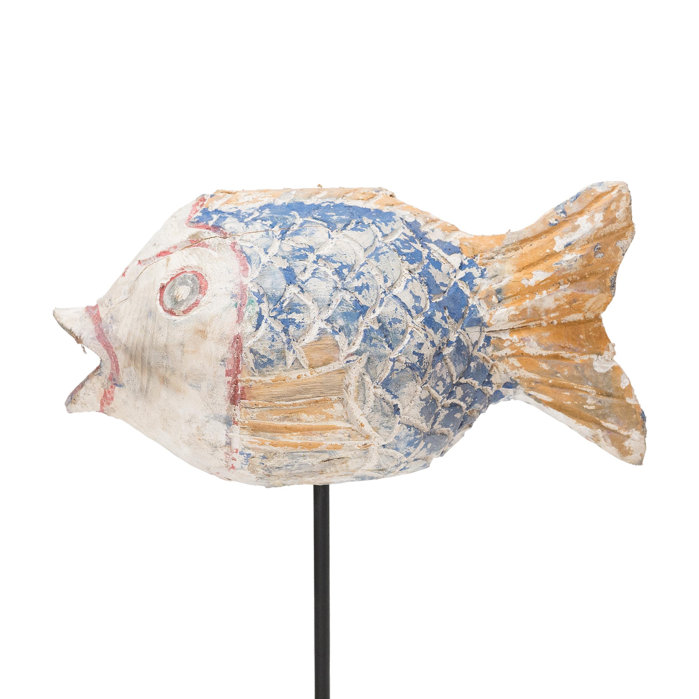 Hand-crafted from reclaimed wood, this artisanal koi sculpture is a traditional symbol of harmony and luck. For Buddhists, such a fish represents a freedom from all restraints. And because fish are reputed to swim in pairs, two fish paired together