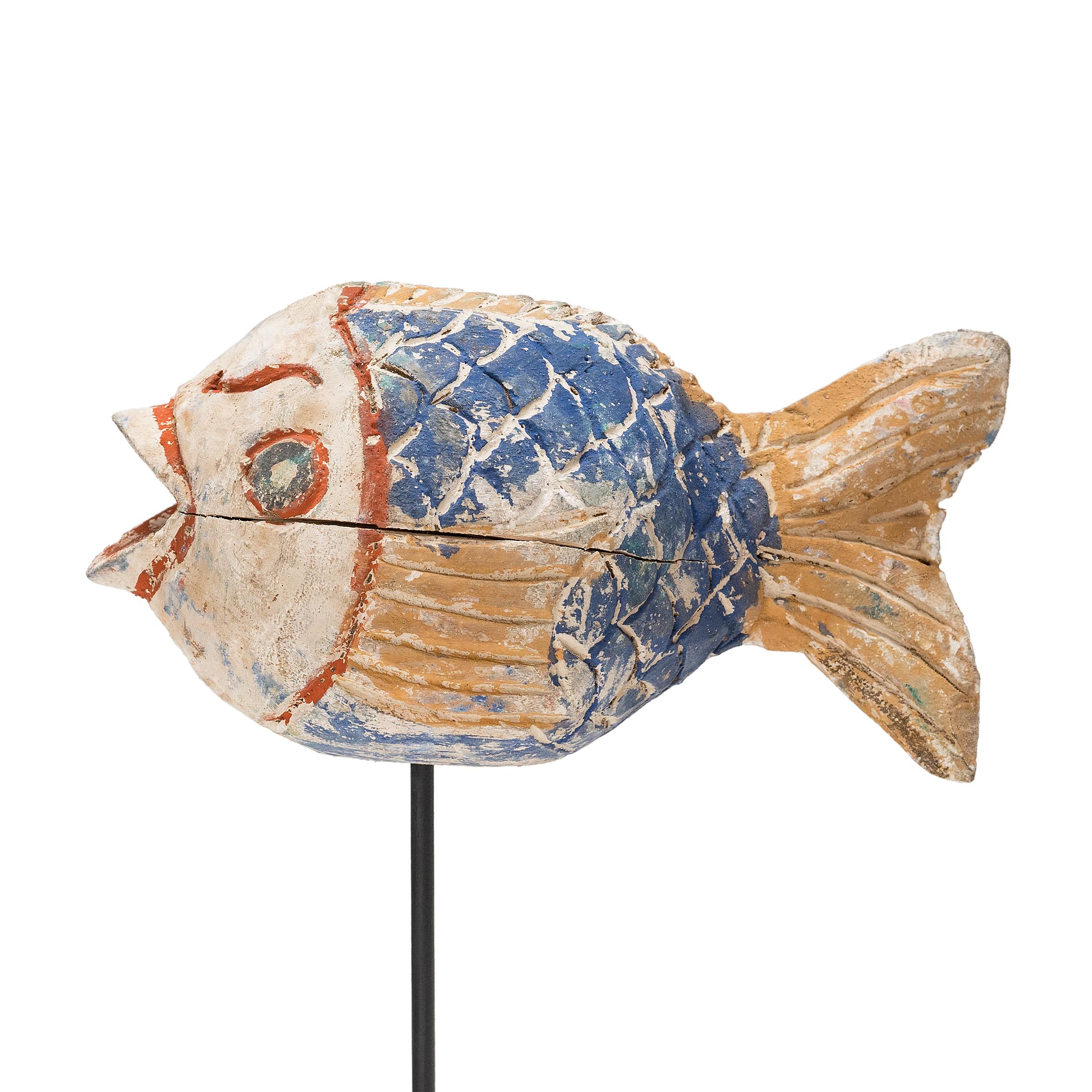 Hand-crafted from reclaimed wood, this artisanal koi sculpture is a traditional symbol of harmony and luck. For Buddhists, such a fish represents a freedom from all restraints. And because fish are reputed to swim in pairs, two fish paired together