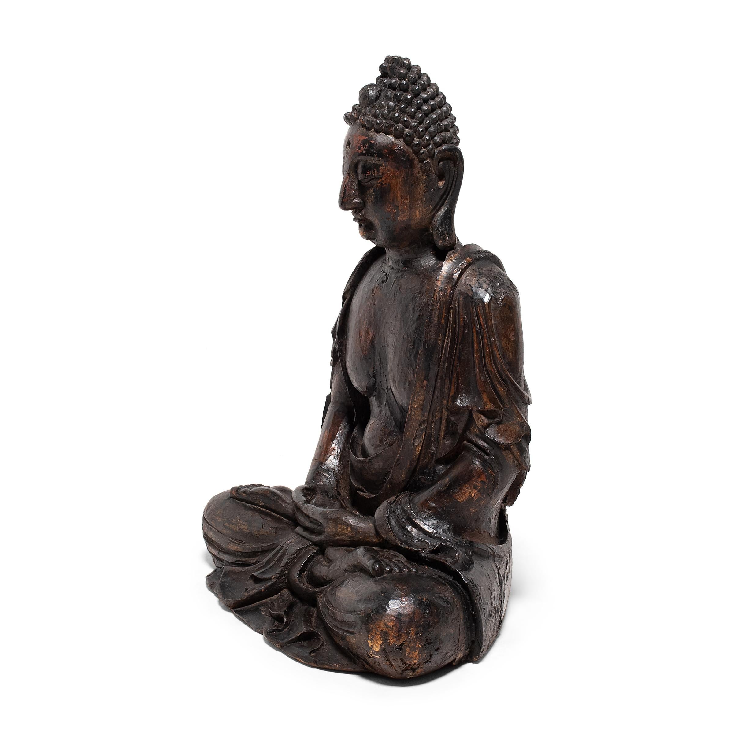 This large wooden figure depicts the Buddha Shakyamuni in perpetual meditation. Also known as Shaka or Siddhartha Gautama, the historical Buddha Shakyamuni is revered as a fully enlightened being and the source of all Buddhist teachings.