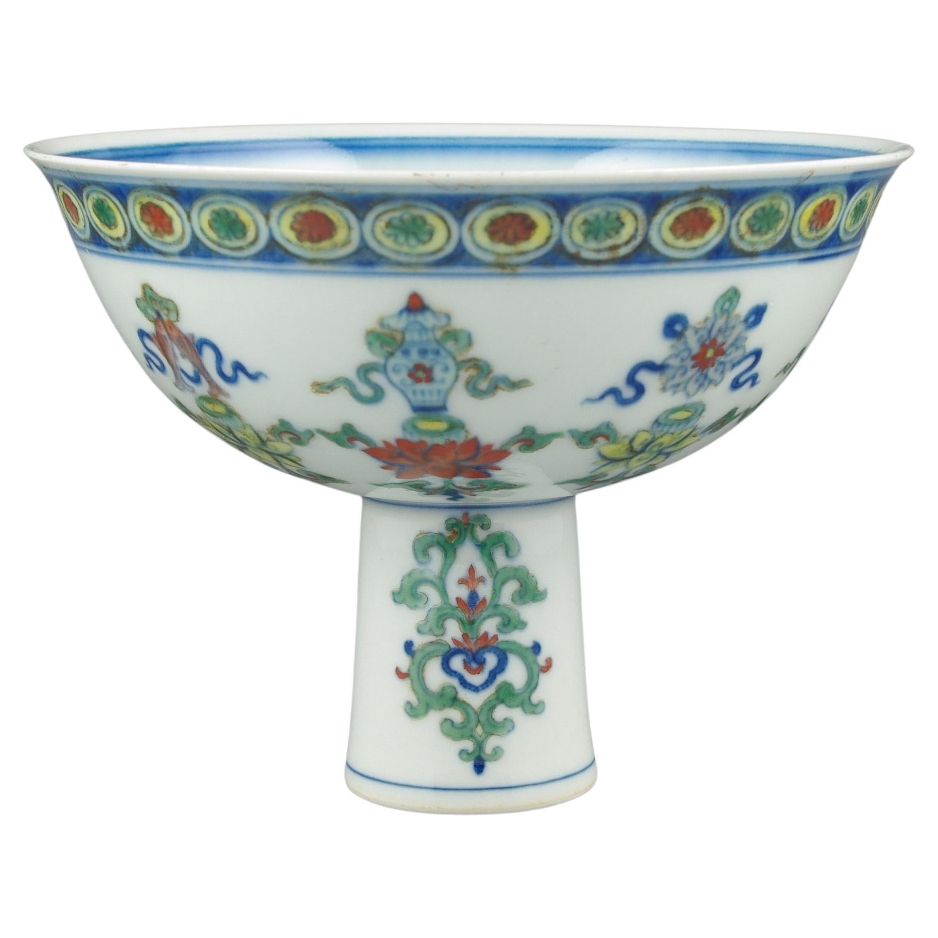 A rare and unique Chinese porcelain footed bowl, intricately adorned with underglaze blue and doucai techniques, showcases the revered eight Buddhist treasures on its exterior. The interior presents a harmonious design, featuring a double circle
