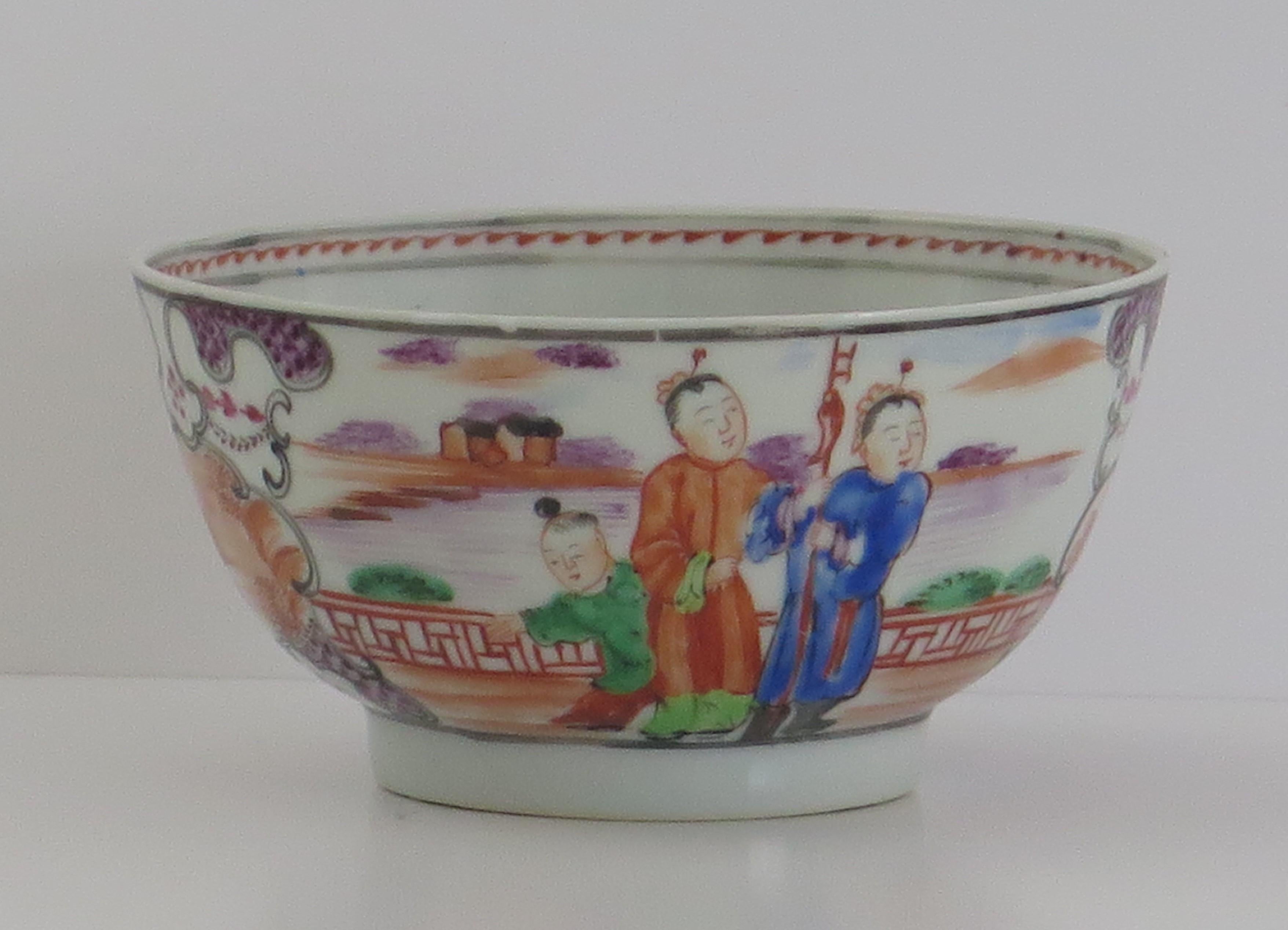 This is a finely hand painted Chinese porcelain bowl from the 18th century, Qing dynasty, Qianlong period, 1736-1795.

The bowl is beautifully decorated with two panels of figure scenes alternating with two magenta border panels. The figural